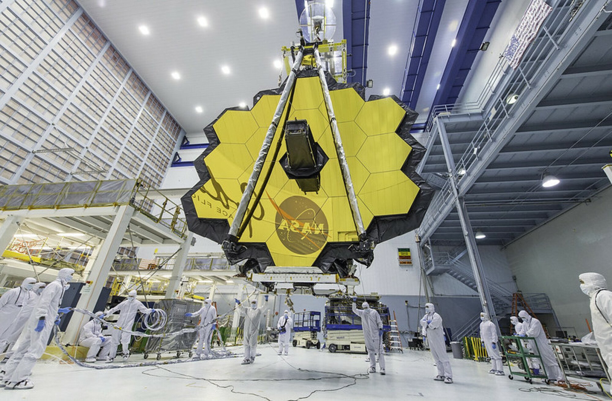Engineers working on the James Webb Space Telescope's giant, gold-coated mirror.
