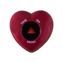 Imagine a magic eight ball, but it's heart-shaped and red. Around the window that reveals the die inside are the words "finish this sentence."