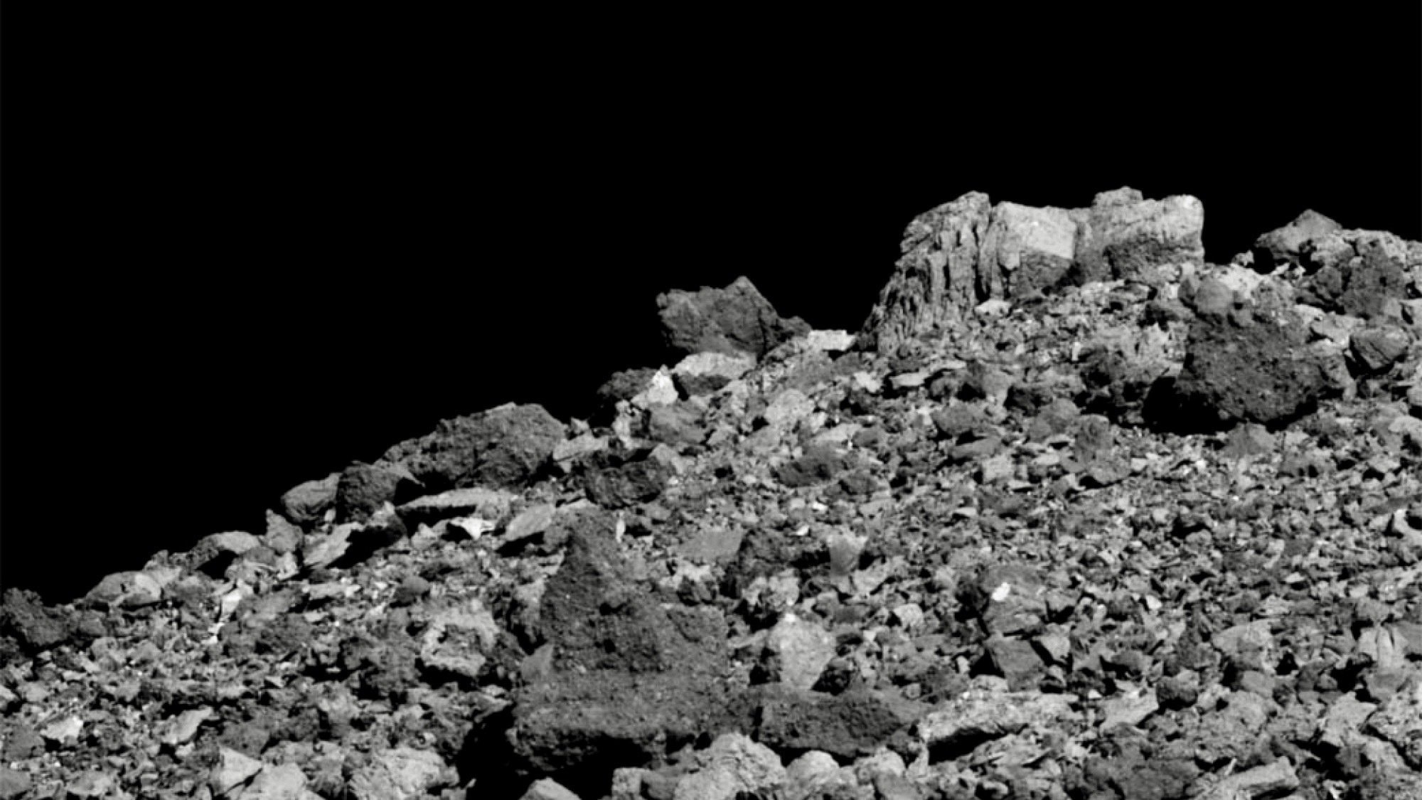 NASA spacecraft observing asteroid Bennu rocks