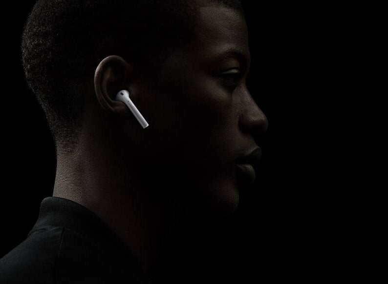 Side profile of a man wearing Apple AirPods 