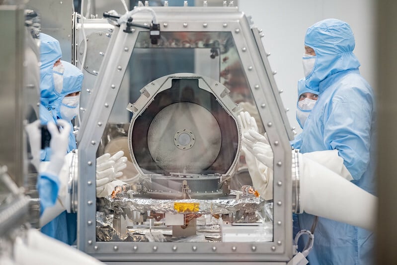 NASA scientists opening the OSIRIS REx Asteroid Sample Return lid at the Johnson Space Center.