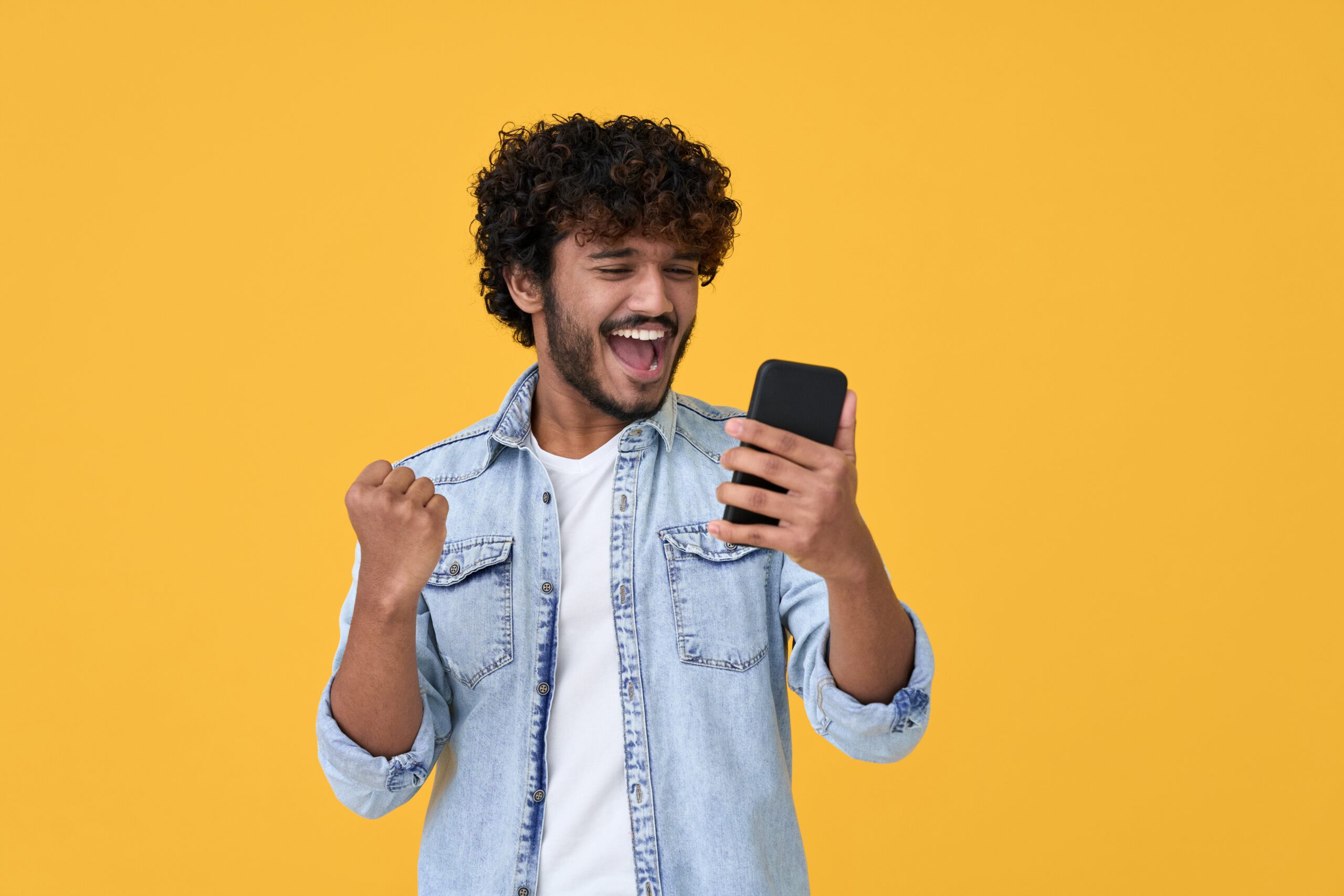 excited man holding phone