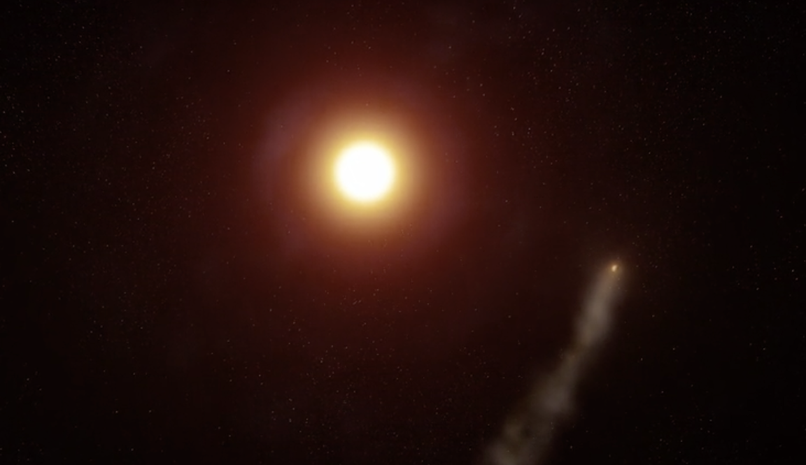 A conception of exoplanet WASP-69b, with a long tail, orbiting its star.