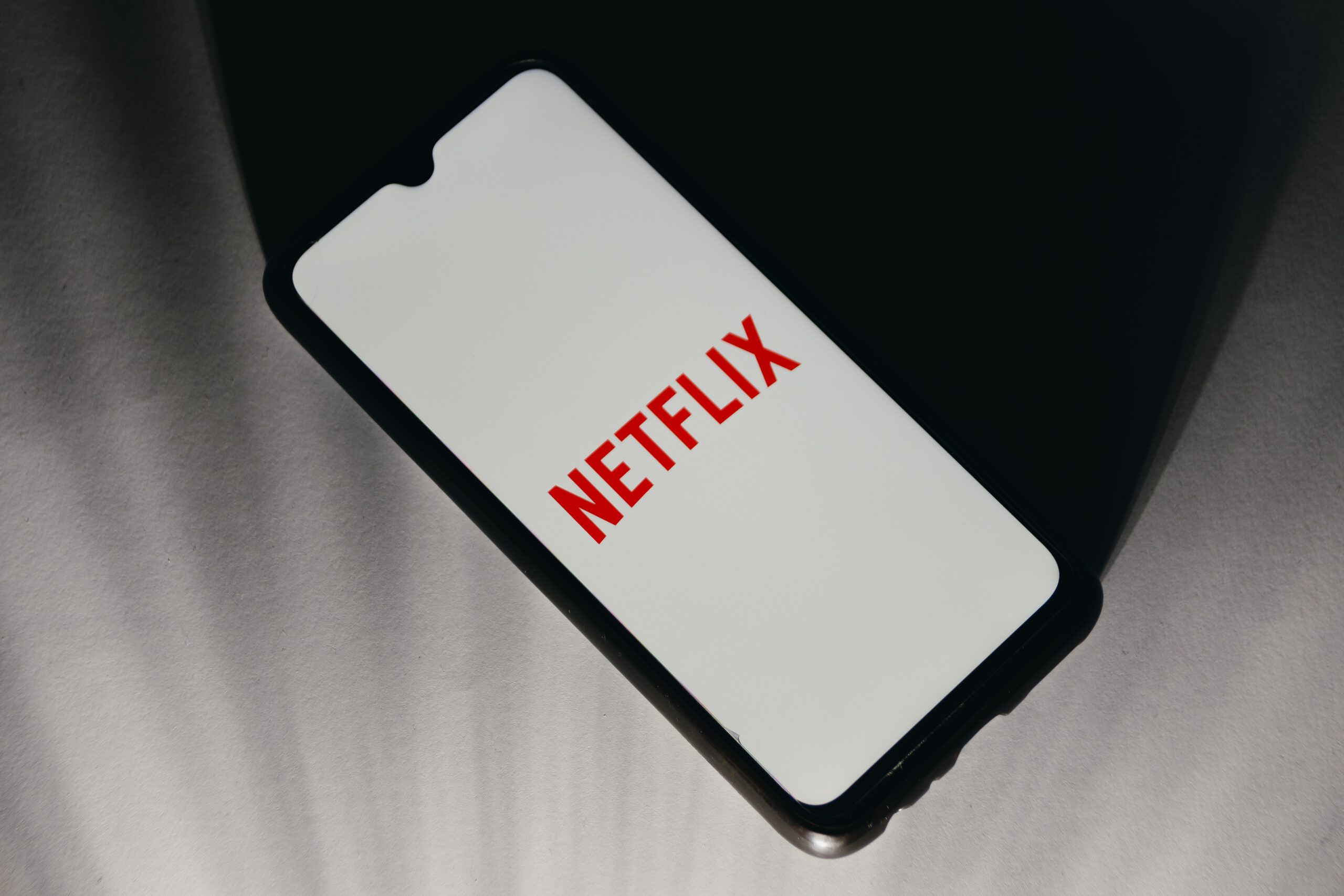 A phone screen displaying the Netflix logo.