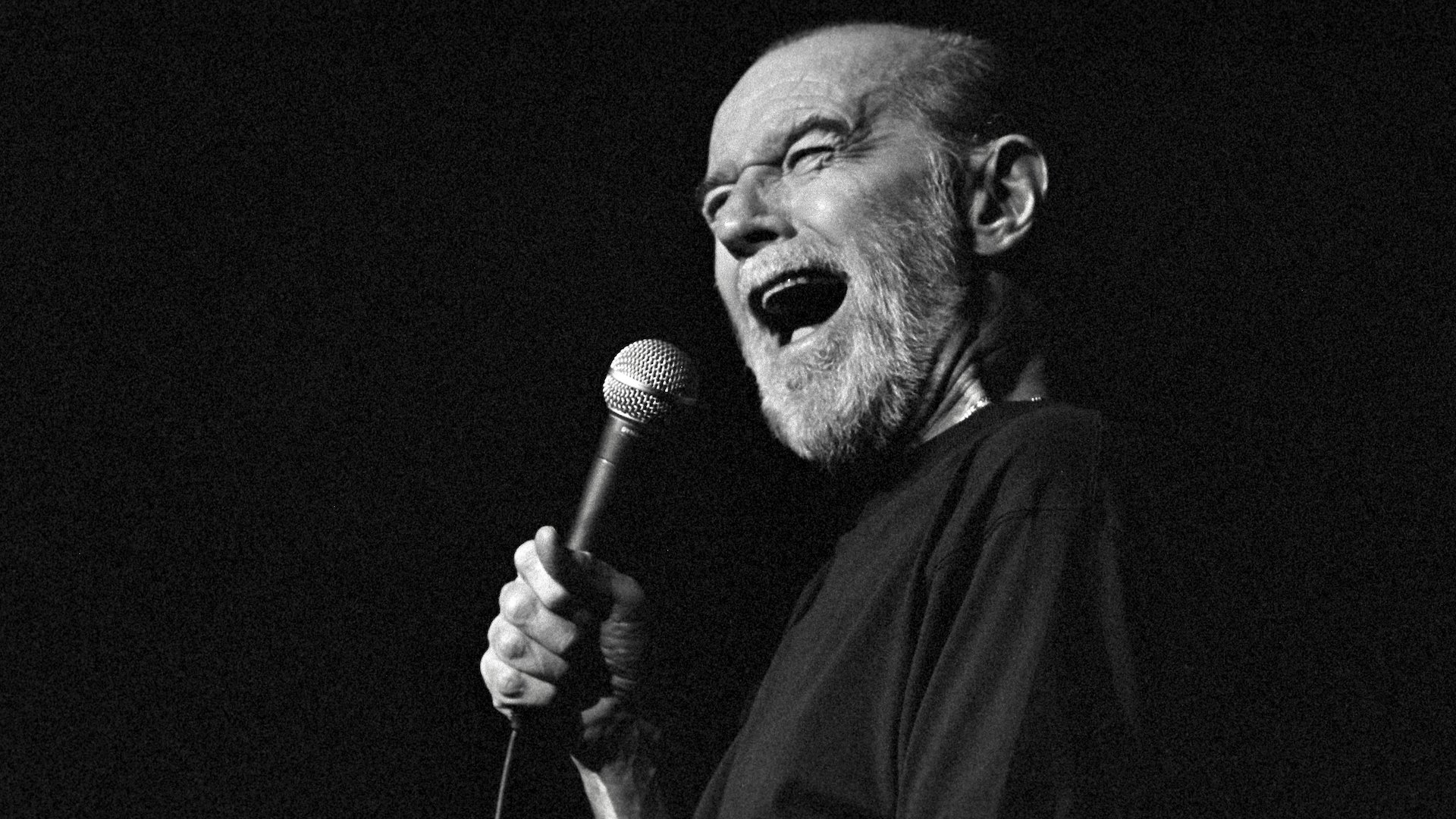 George Carlin performs a standup routine.