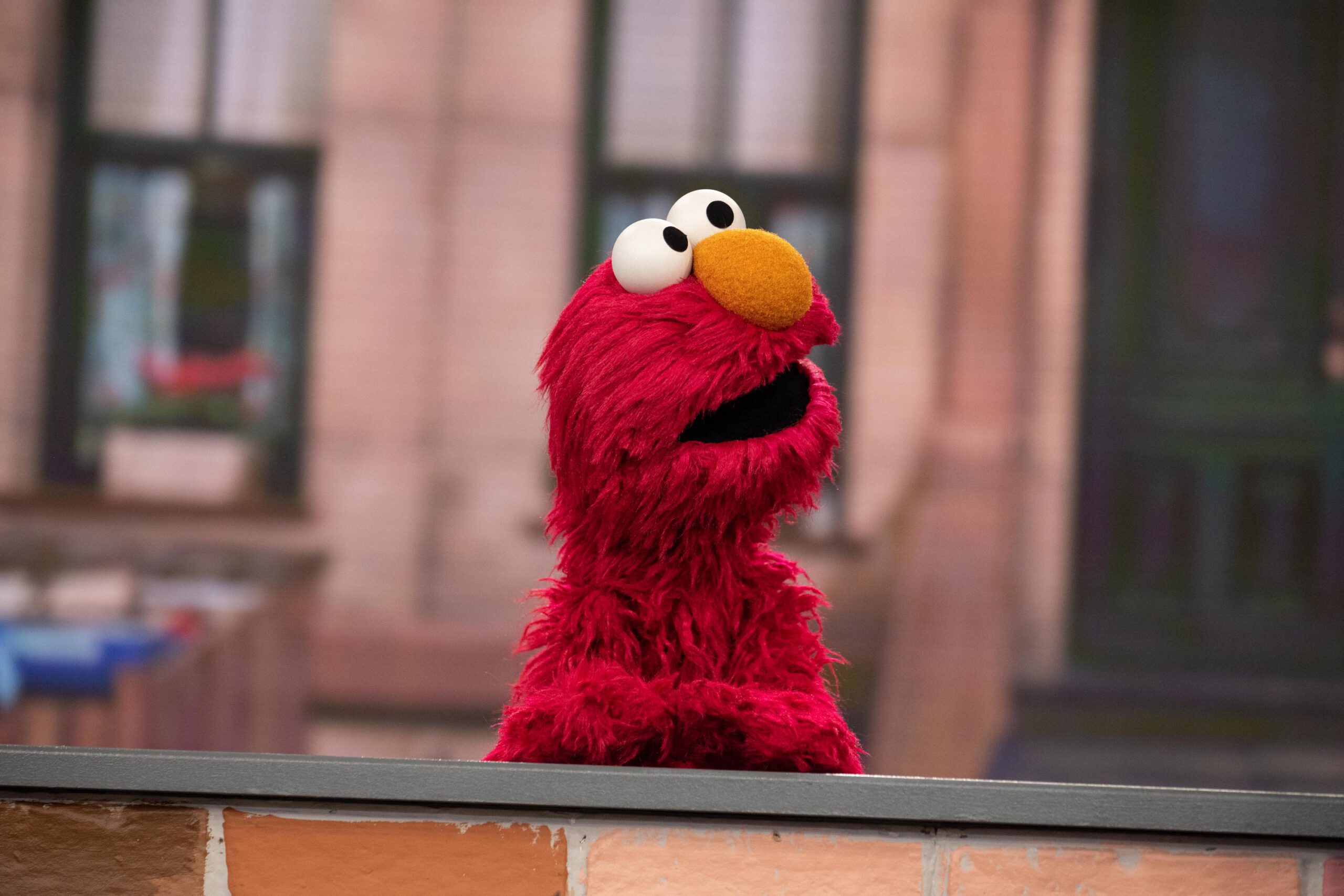 Picture of Elmo standing at a desk