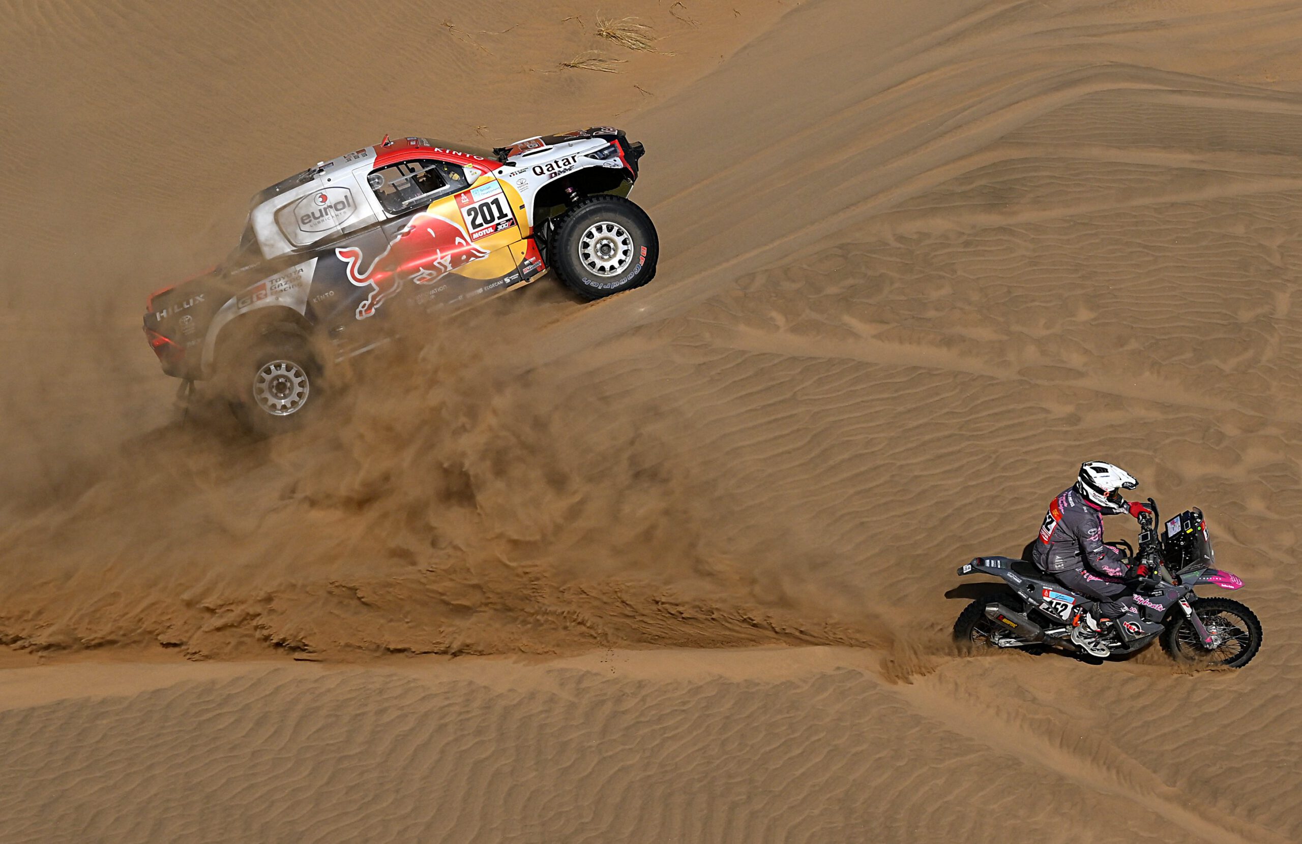 Toyota's driver Nasser Al-Attiyah of Qatar and his co-driver Matthieu Baumel of France compete