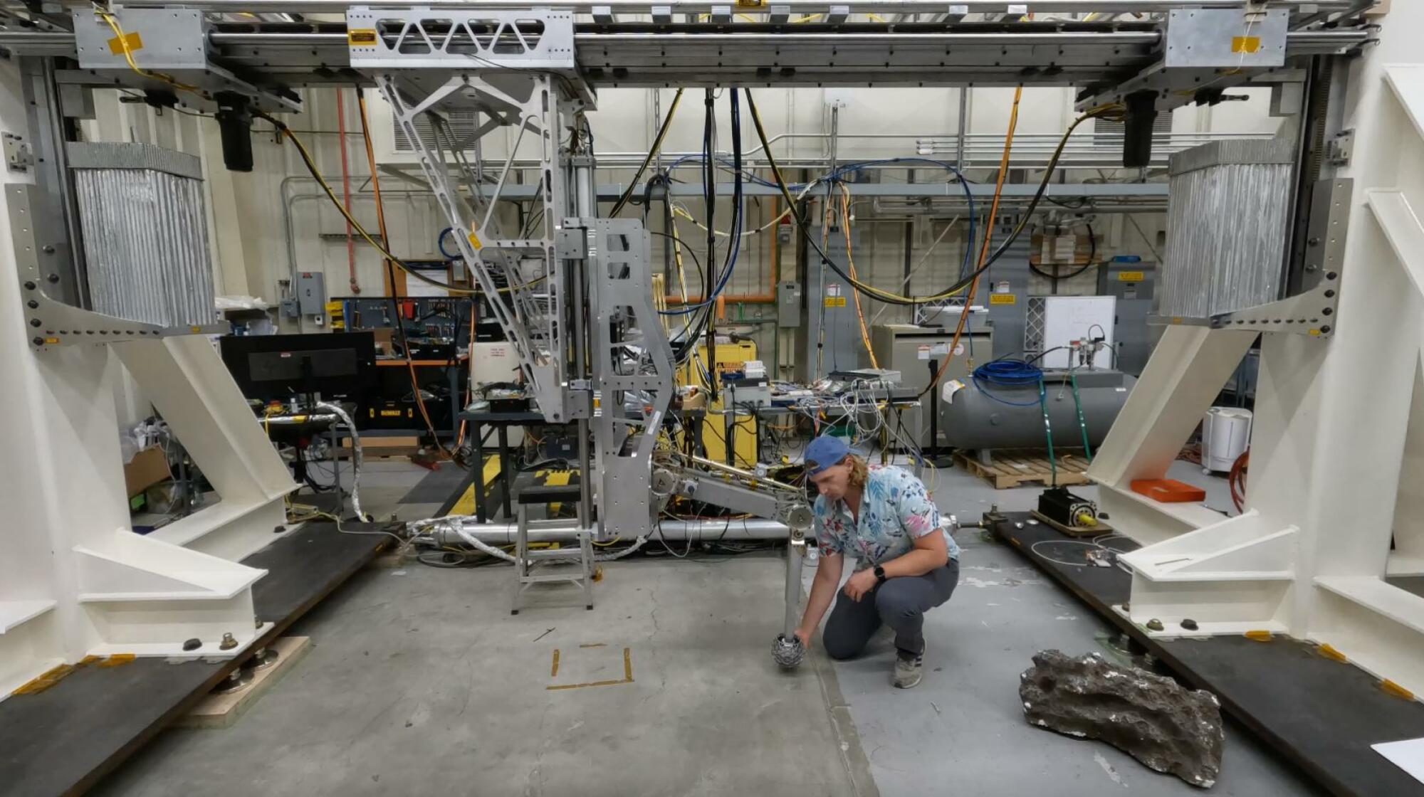 An engineer testing the Europa Lander's landing gear.