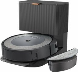 a roomba i5+ combo sits in its emptying base with the mop attachment beside it