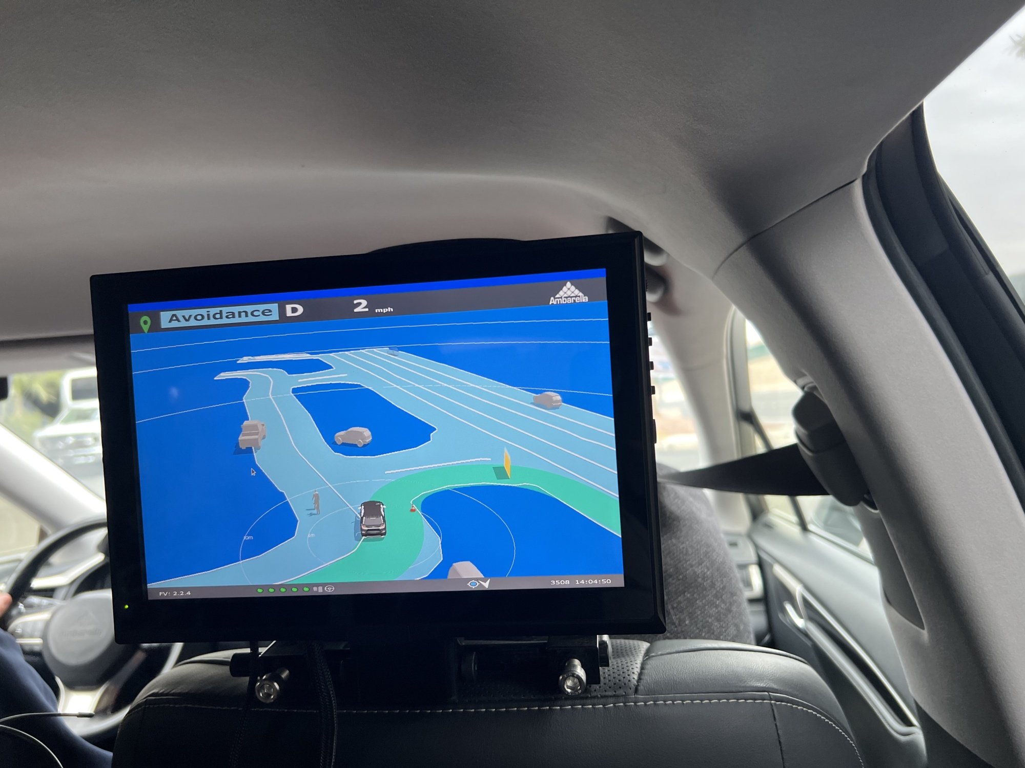 A tv screen attached to the passenger side headrest