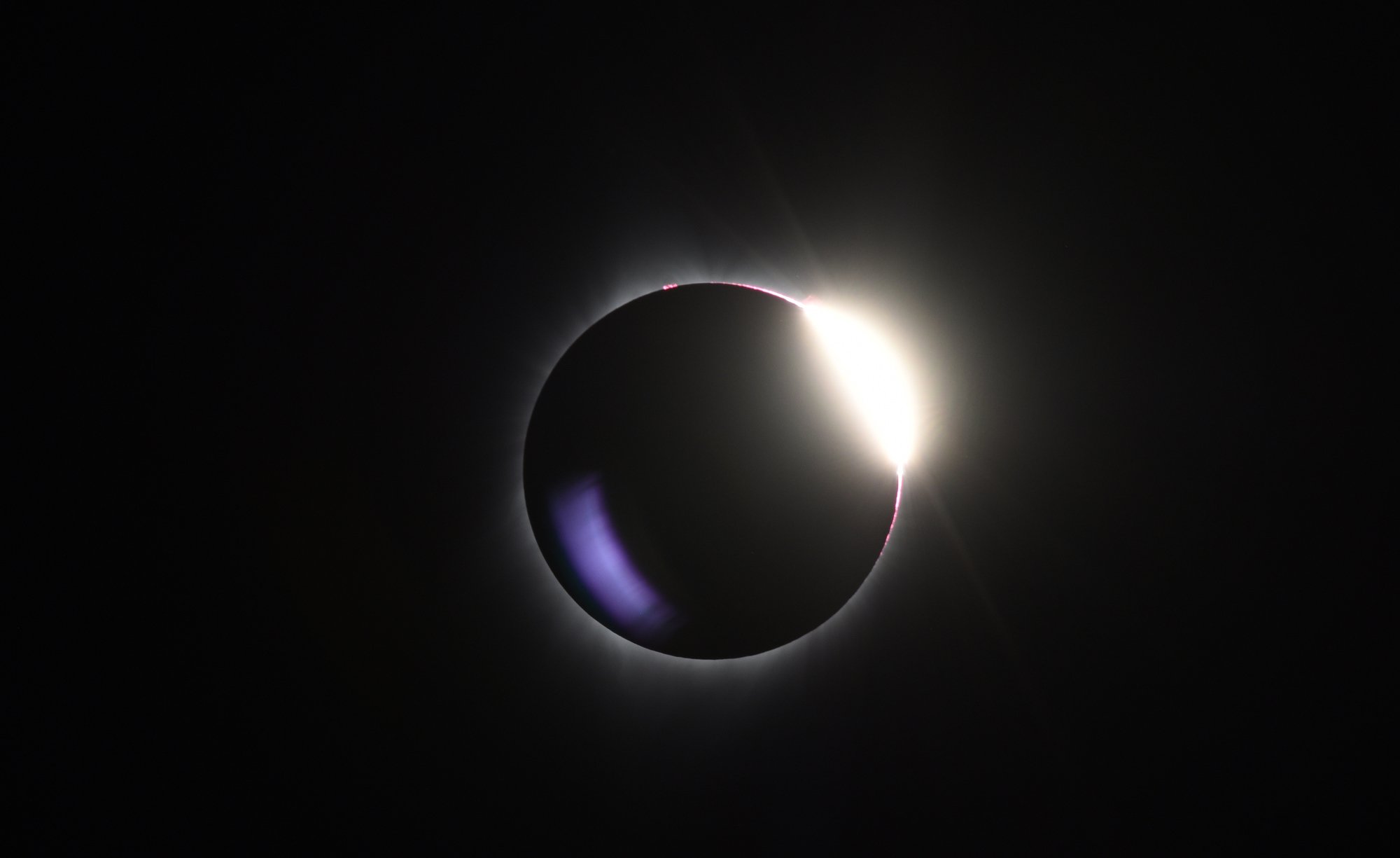 Moon passing over sun during total solar eclipse