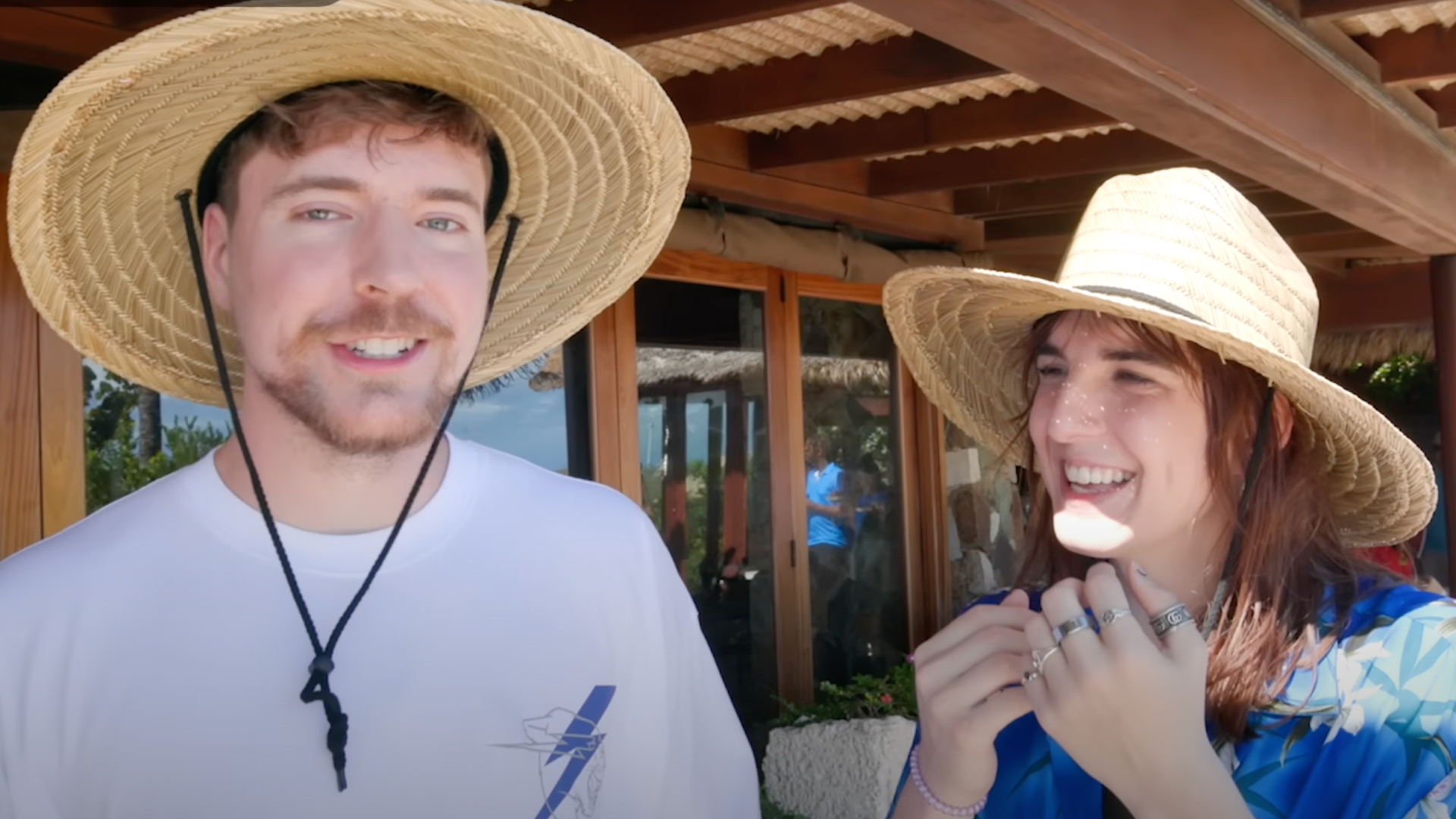 MrBeast in a wide brimmed straw hat next to friend Kris Tyson