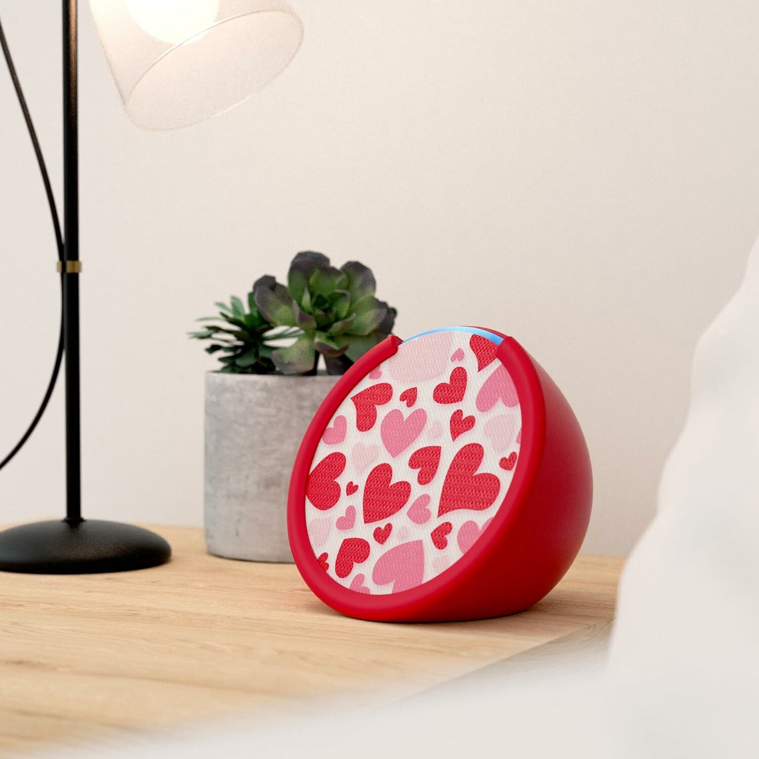 Amazon Echo Pop with red sleeve and hearts faceplate