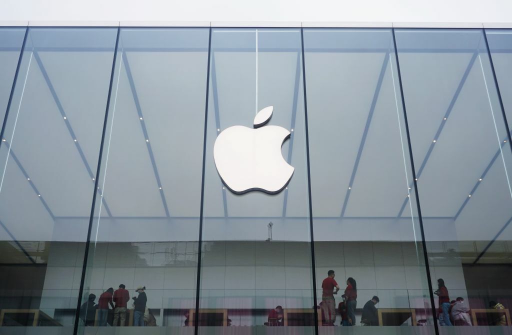 Apple logo prominently featured on the face of an Apple Store
