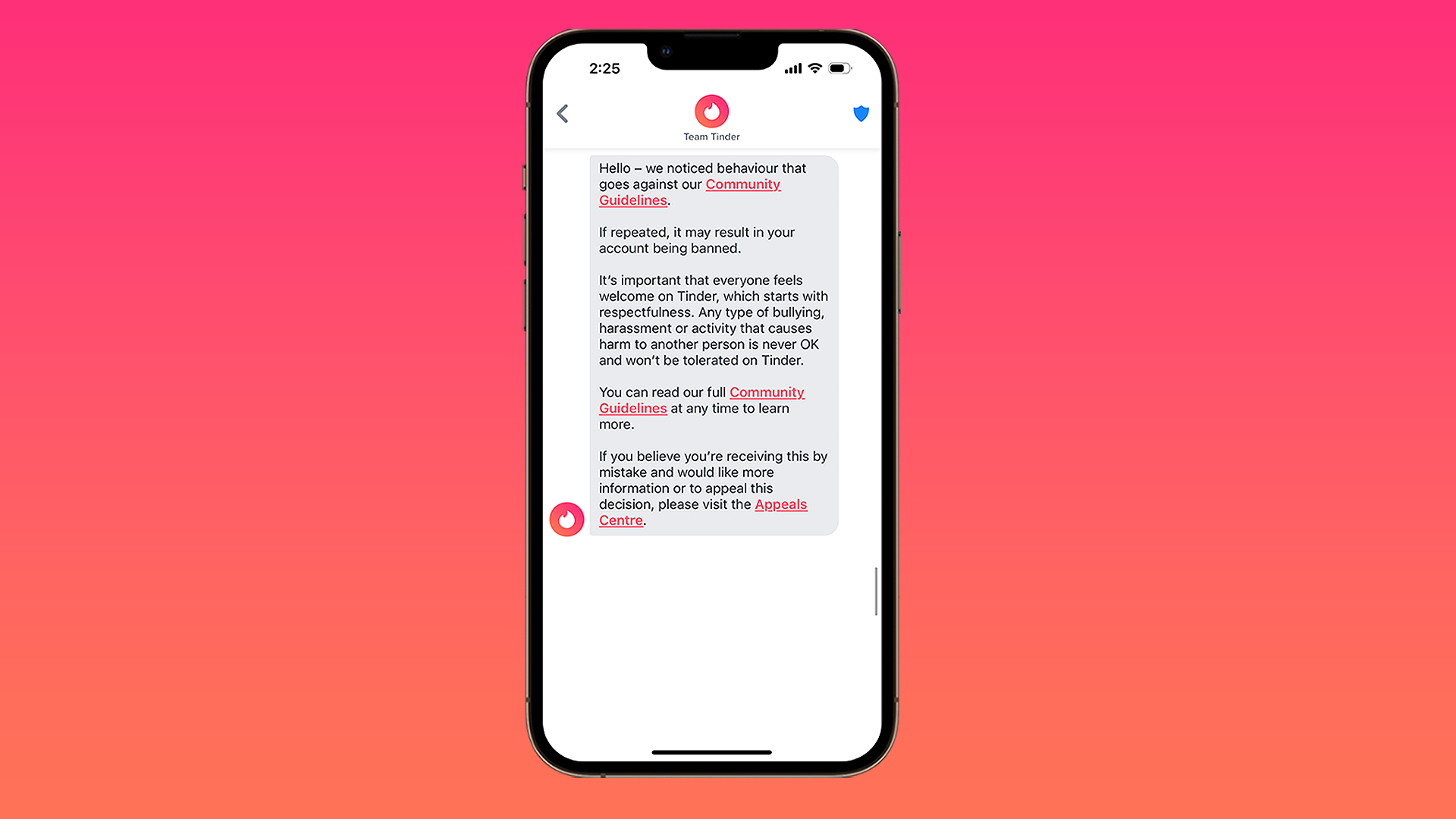 Tinder's new in-app warning in front of pink and orange gradient background.