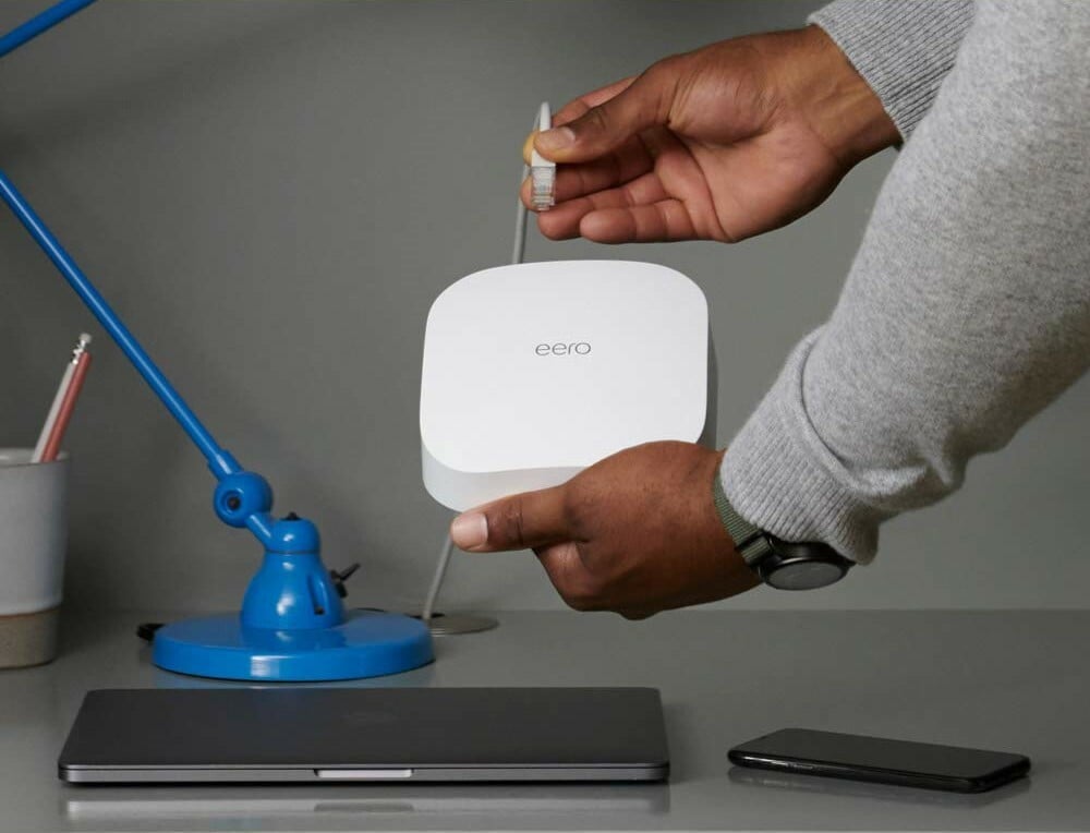 someone plugs an eero pro 6 wifi router into an ethernet cord