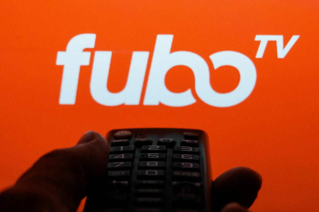 TV remote control is seen with fuboTV logo displayed on a screen in this illustration photo taken in Krakow, Poland on February 6, 2022.