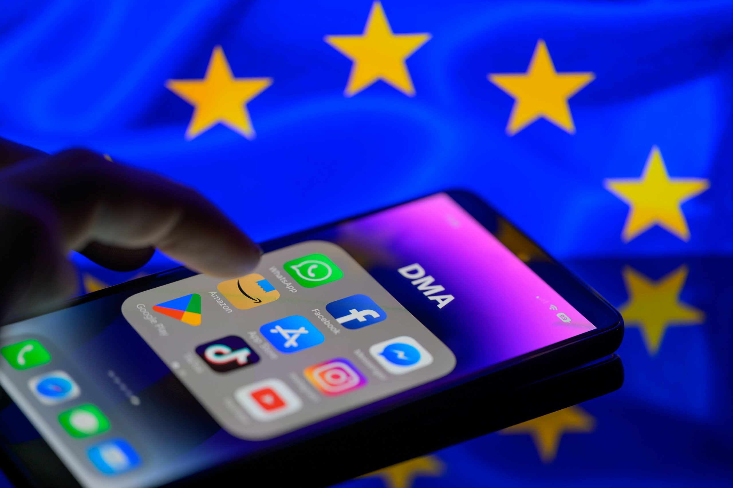 iPhone with apps, EU flag in the background