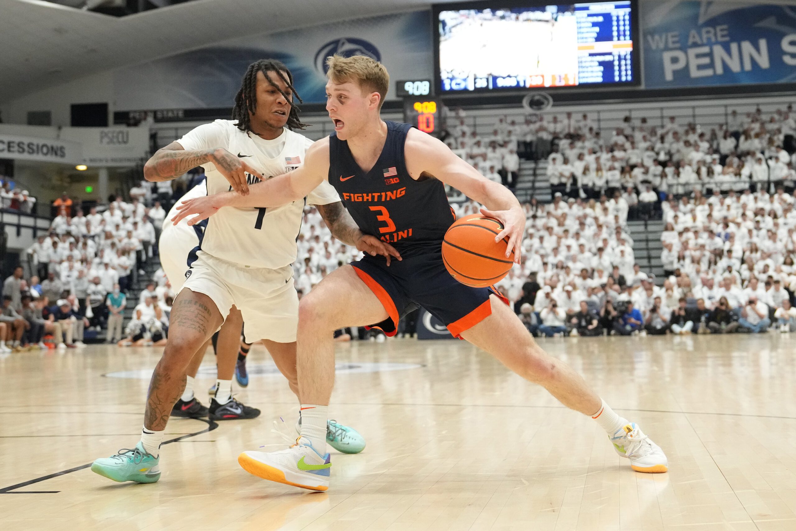 Marcus Domask #3 of the Illinois Fighting Illini dribbles by Ace Baldwin Jr. #1 of the Penn State Nittany Lions in the first half during a college basketball game on Feb. 21, 2024, in University Park, Pennsylvania.