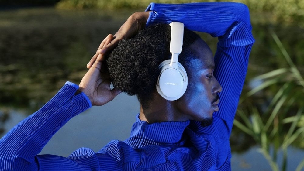person wearing bose quietcomfort ultra headphones outside