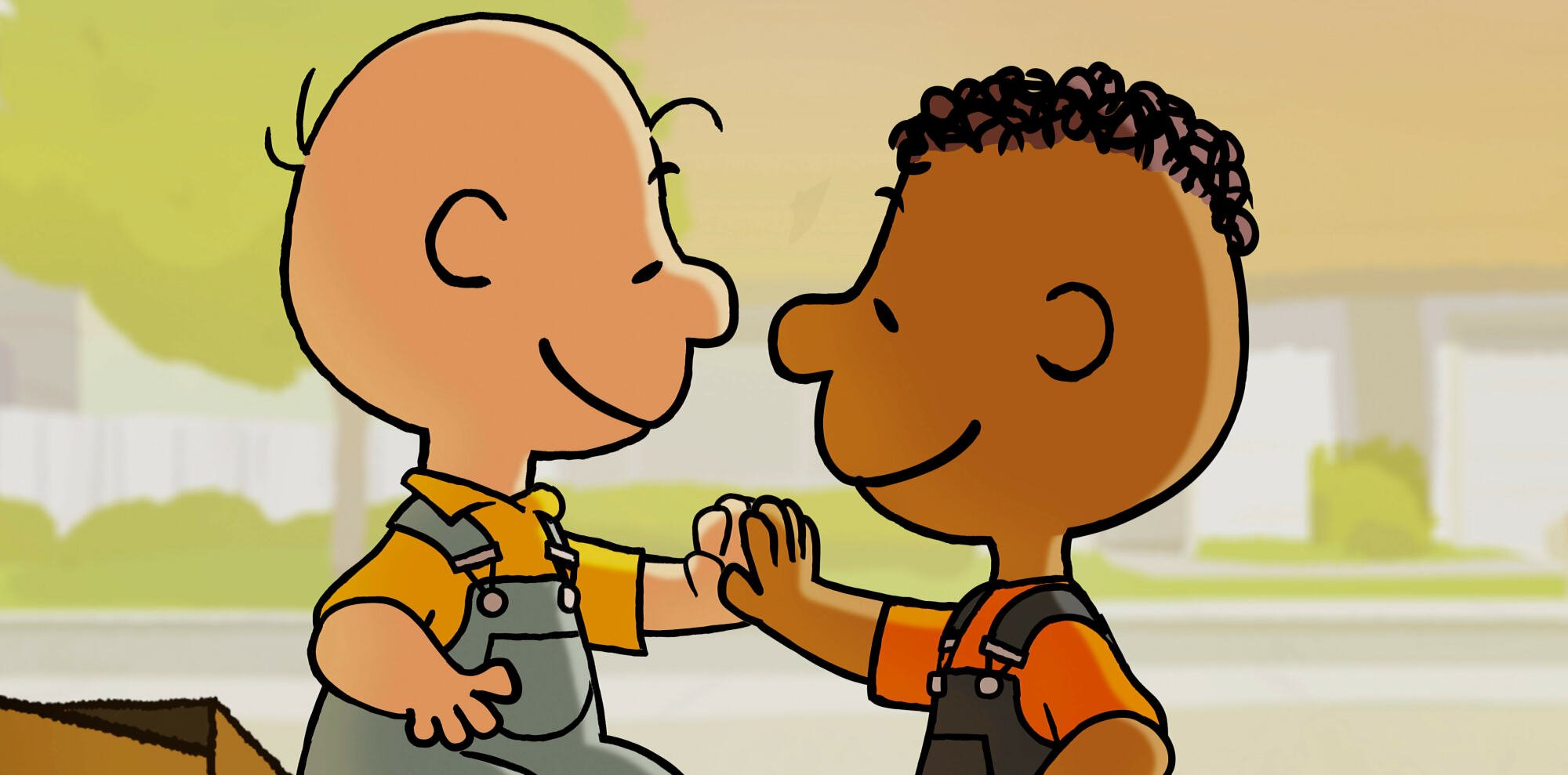 Charlie Brown and Franklin high five each other. 