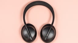 black bose 700 headphones on coral background