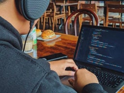 man coding on laptop