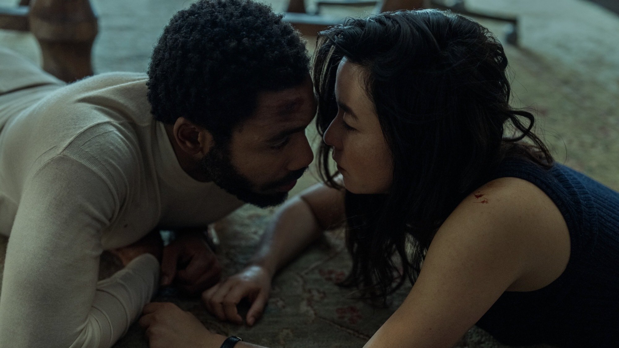 Donald Glover and Maya Erskine are on the floor in "Mr. and Mrs. Smith."