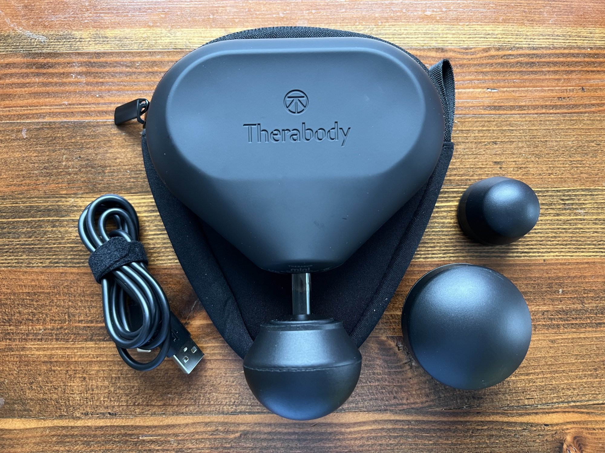 theragun mini with its attachments and charging cable