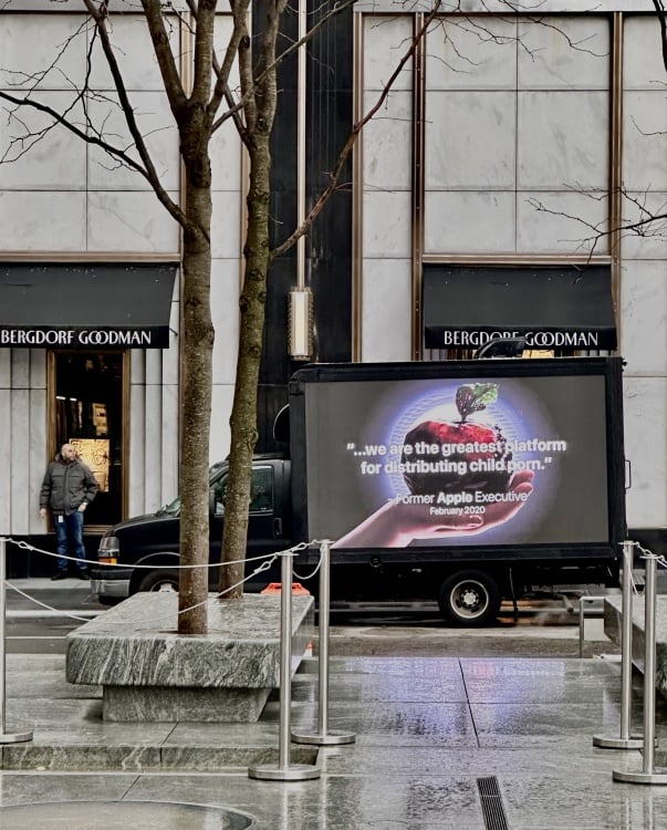 A large screen on the side of a truck reads, "...we are the greatest platform for distributing child porn." - former Apple executive, February 2020.