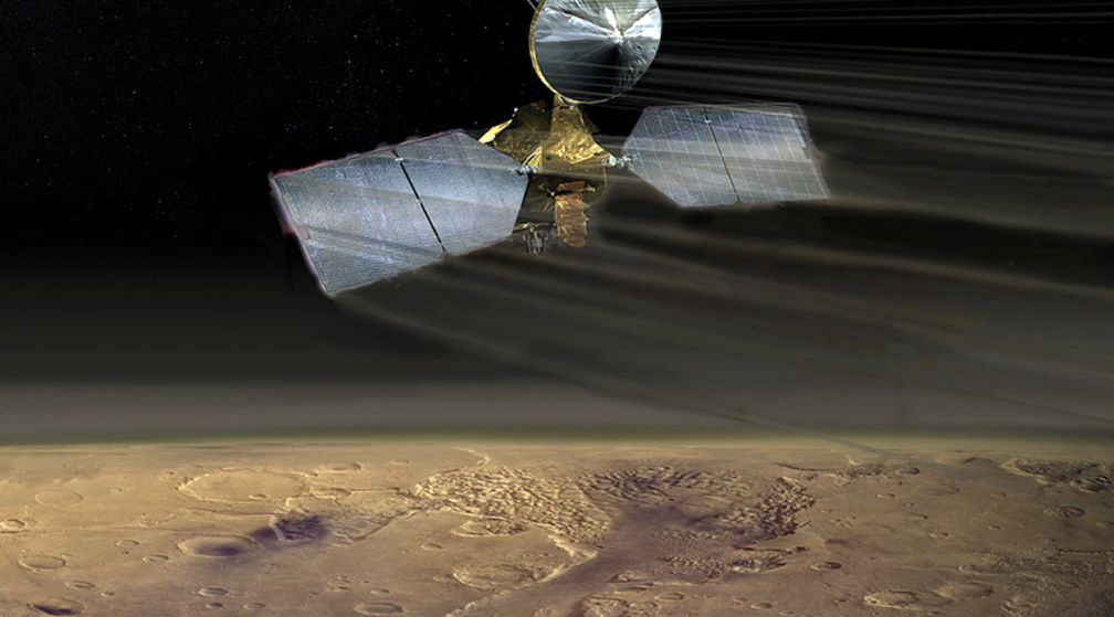 An artist's conception of the Mars Reconnaissance Orbiter swooping over the Martian desert.