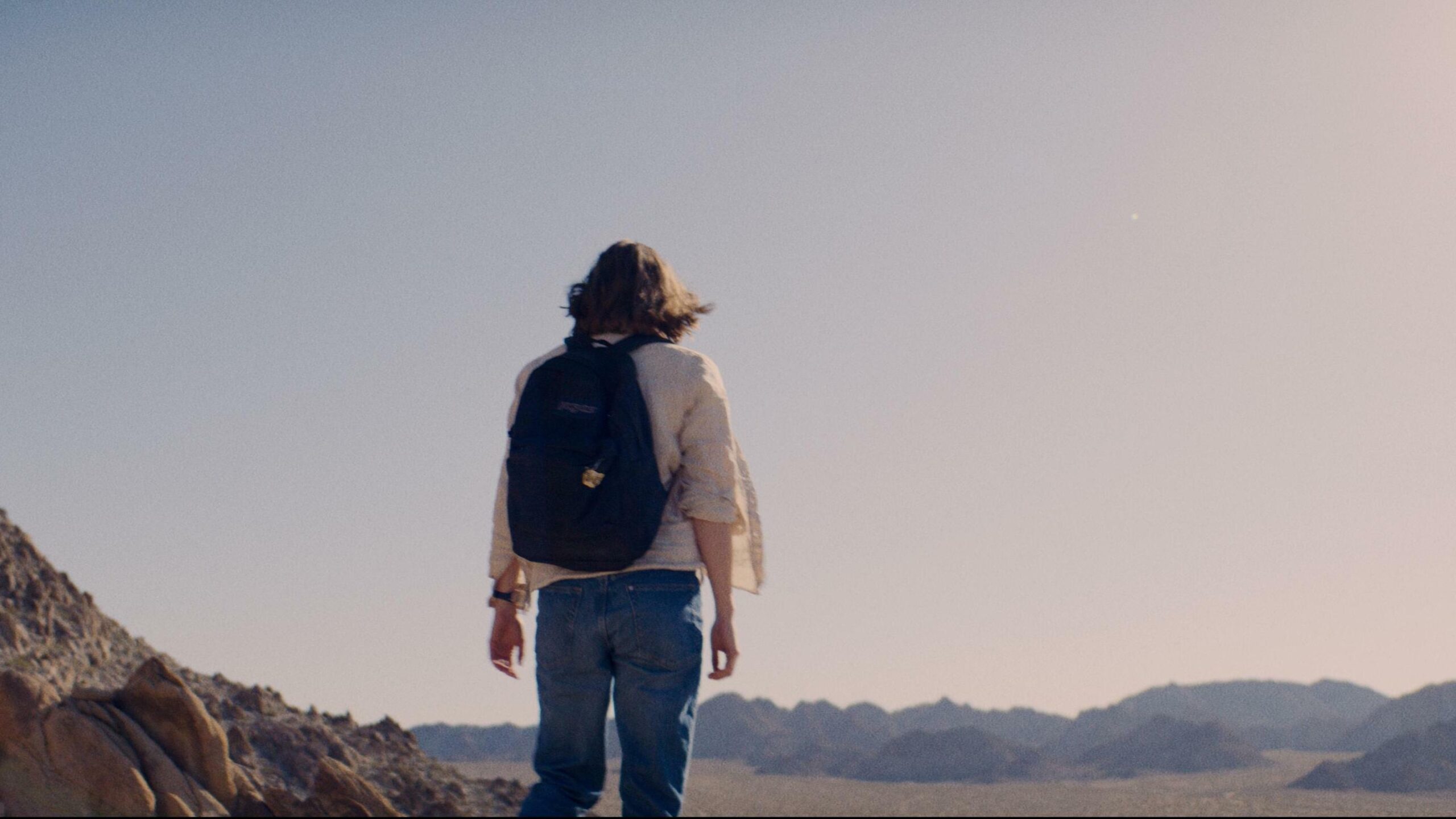 The woman (Kristine Froseth) looks out across the vast desert before her, with no hope in sight.