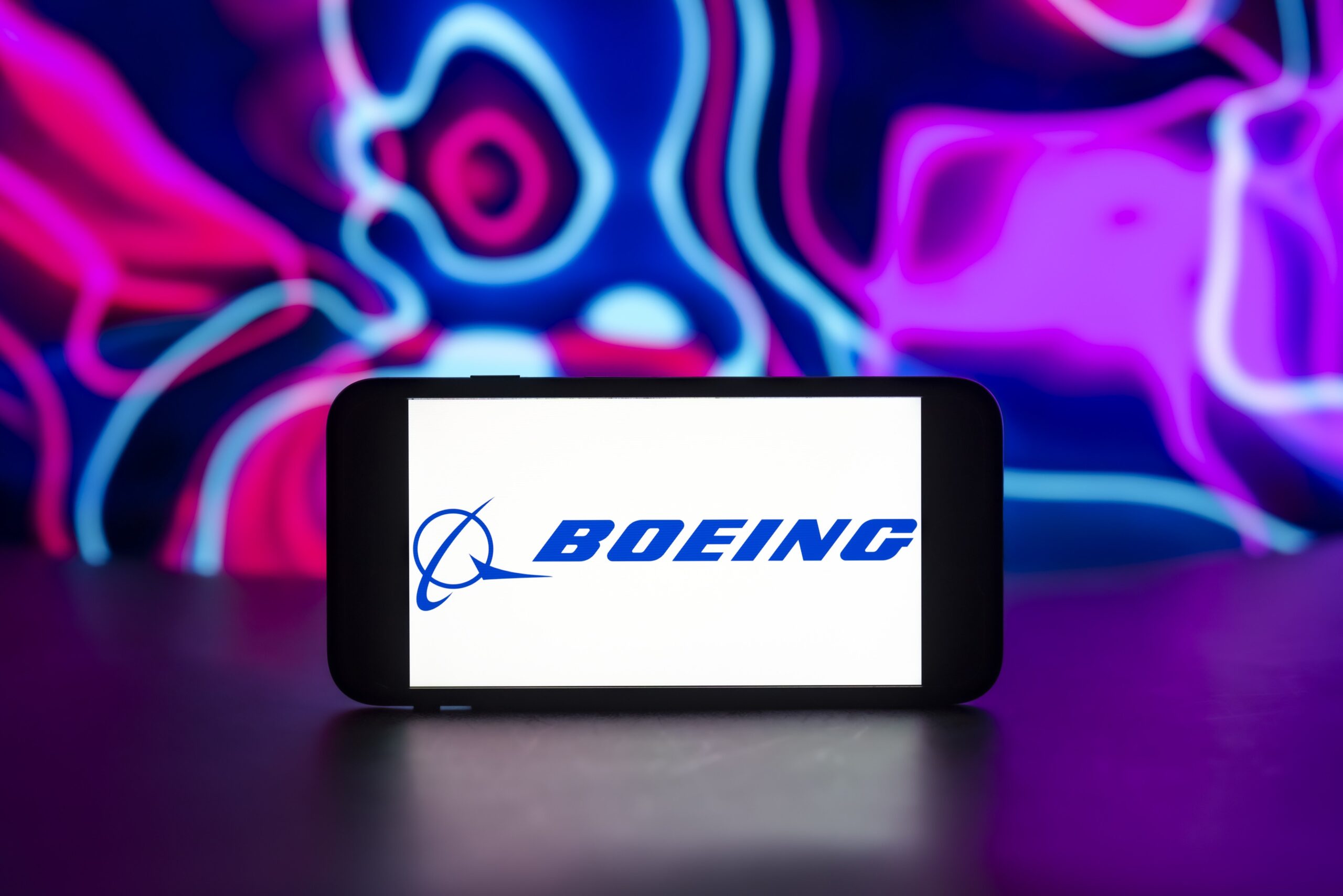 boeing logo on a phone with colorful background