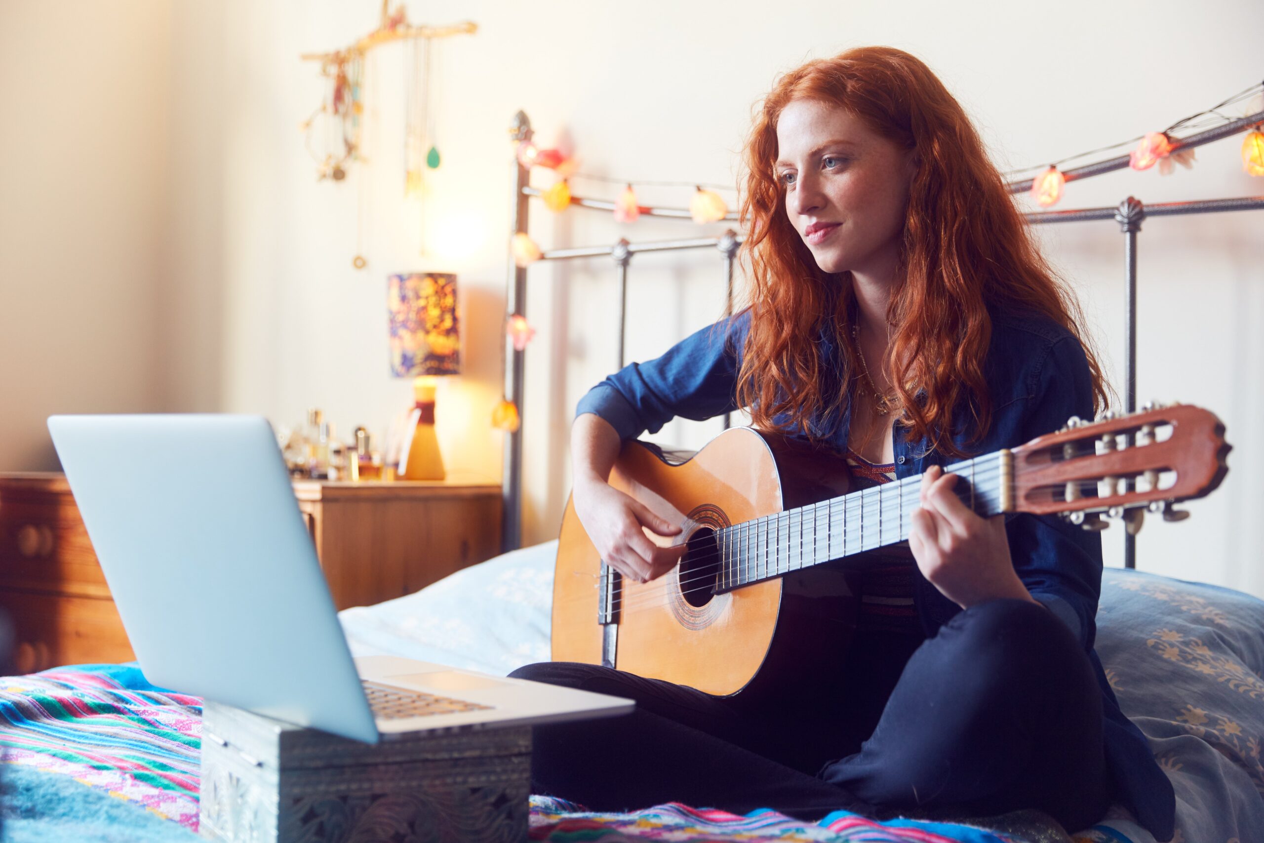 woman doing online lesson with guitar