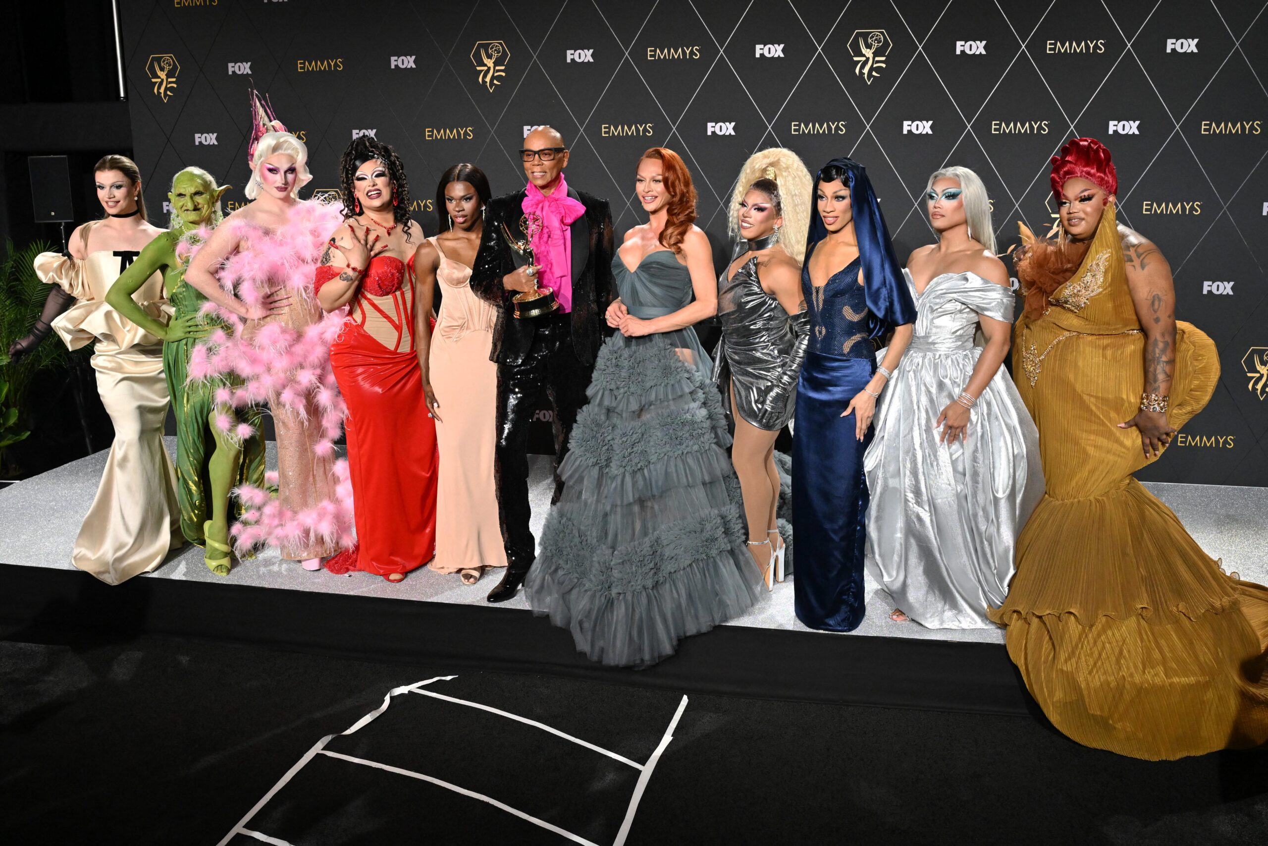RuPaul and drag queens posing at the Emmy's.