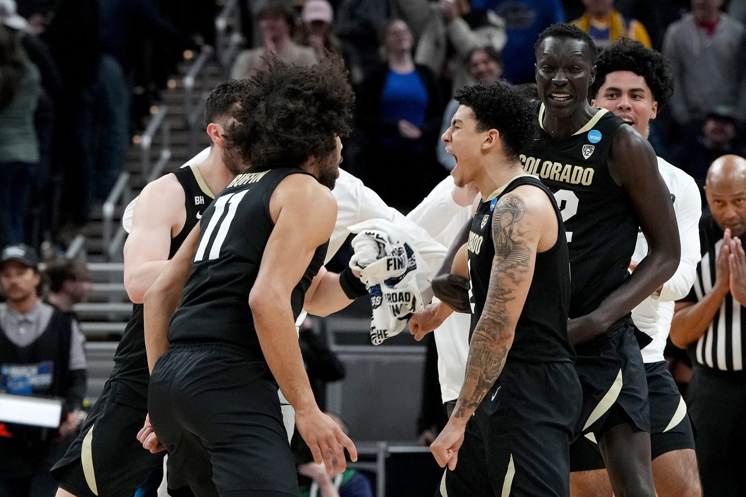 KJ Simpson #2 of the Colorado Buffaloes celebrates with his teammates after hitting the game-winning shot to defeat the Florida Gators in the first round of the NCAA Men's Basketball Tournament at Gainbridge Fieldhouse on March 22, 2024, in Indianapolis, Indiana.