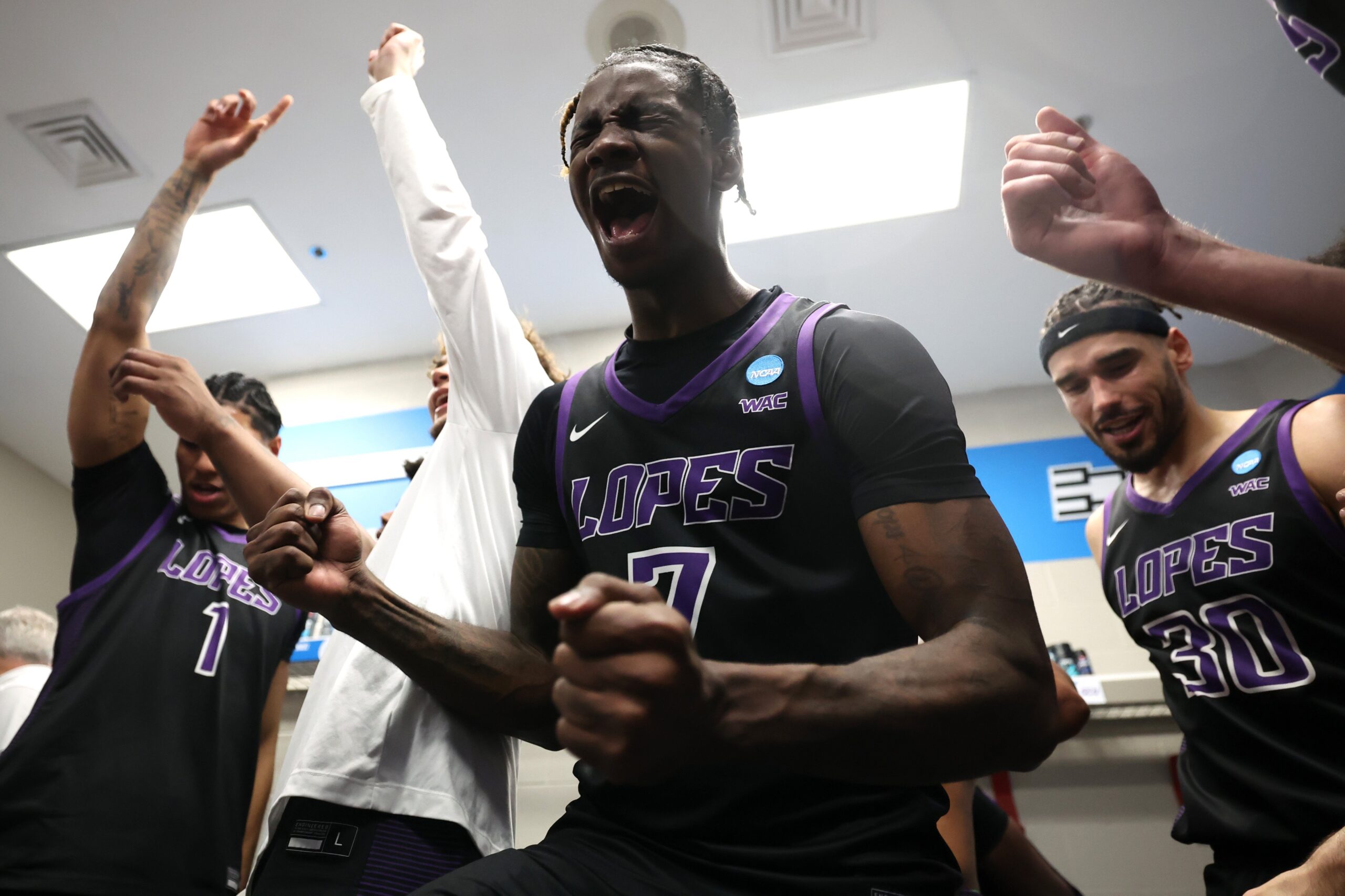 Tyon Grant-Foster #7 of the Grand Canyon Antelopes celebrates with teammates in the locker room following his team's victory against the St. Mary's Gaels in the first round of the NCAA Men's Basketball Tournament at Spokane Veterans Memorial Arena on March 22, 2024, in Spokane, Washington.