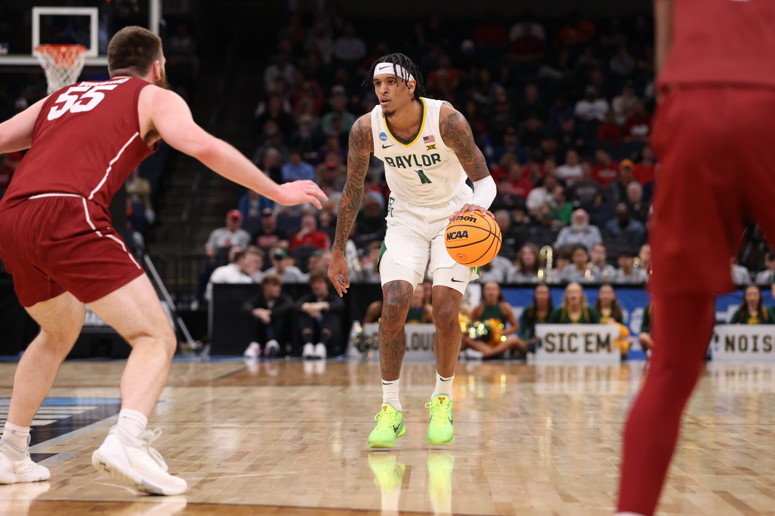 Jalen Bridges #11 of the Baylor Bears is defended by Jeff Woodward #55 of the Colgate Raiders during the first round of the 2024 NCAA Men's Basketball Tournament held at FedExForum on March 22, 2024, in Memphis, Tennessee.