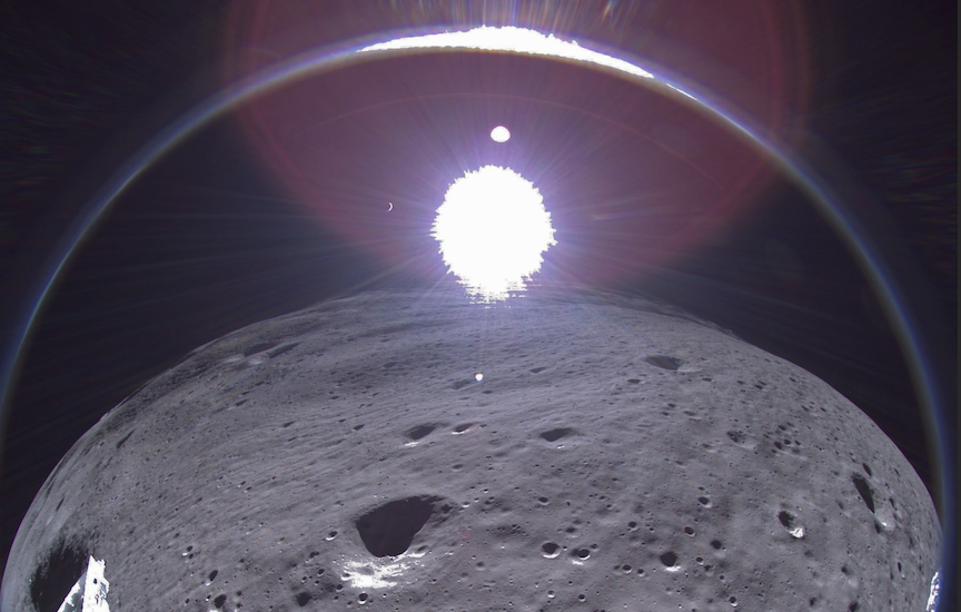 A transmission from Intuitive Machines' Odysseus moon lander showing the crescent Earth near the top of the image, to the left of center.
