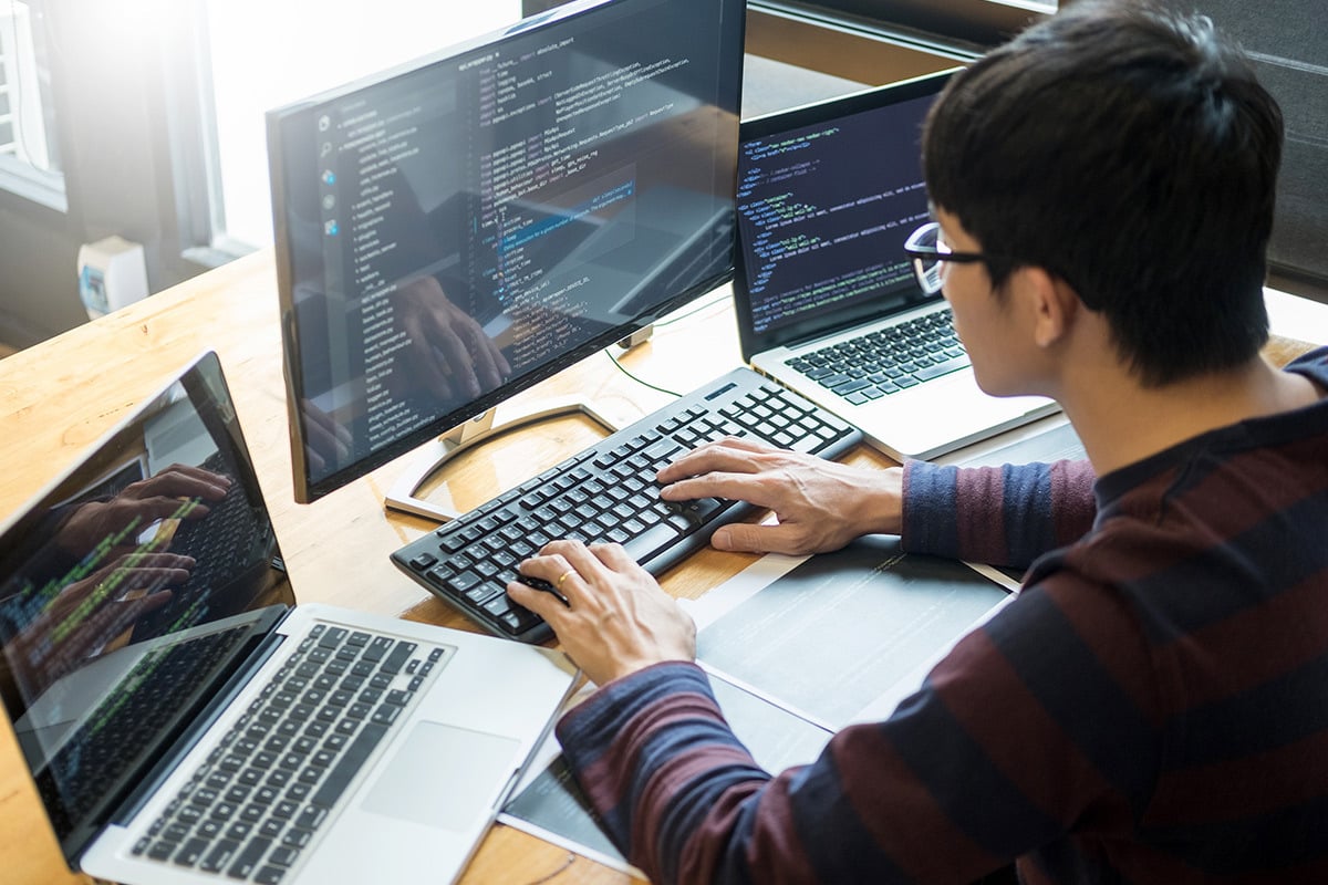 Man using programming bundle on desktop computer