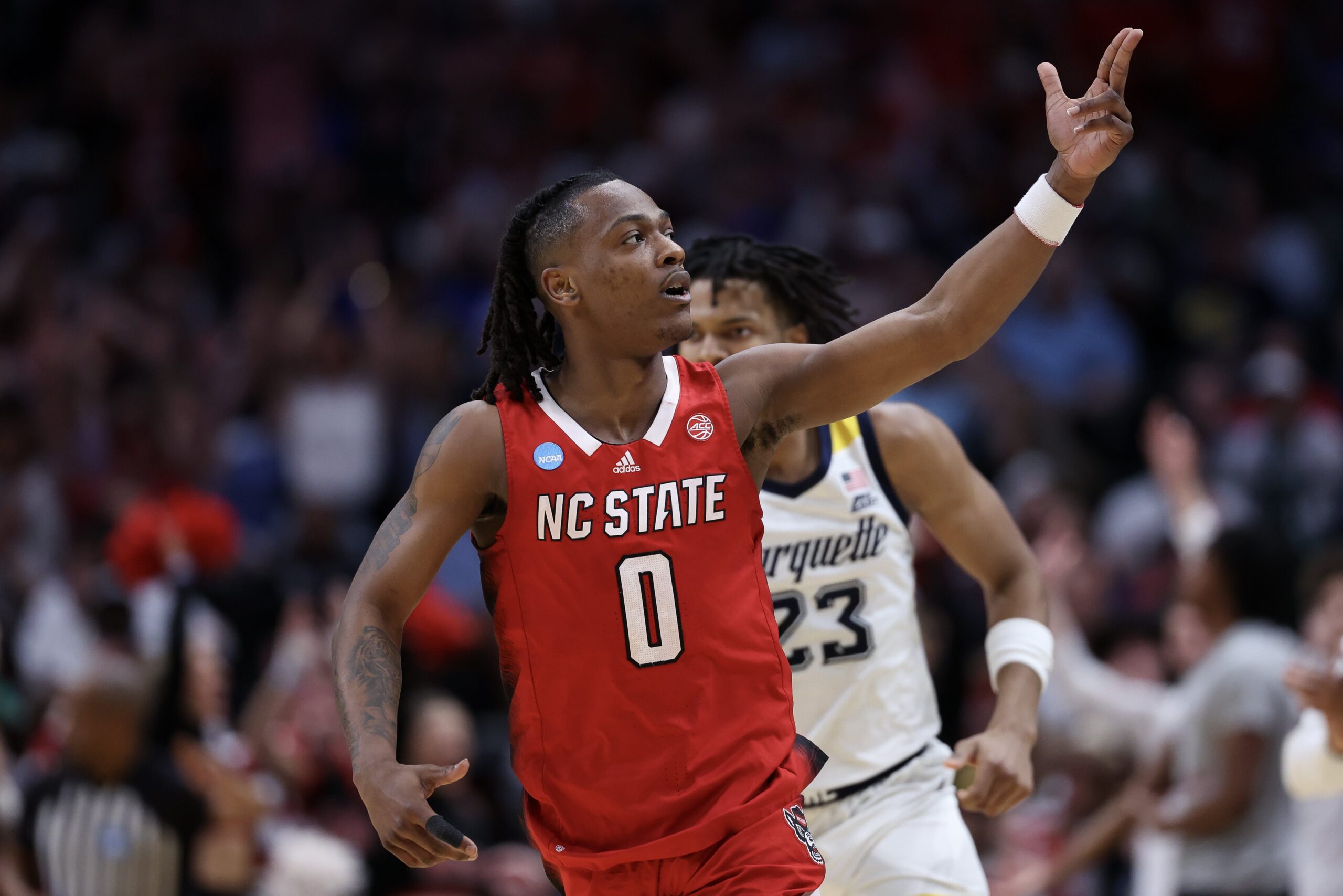 DJ Horne #0 of the North Carolina State Wolfpack reacts against the Marquette Golden Eagles during the second half in the Sweet 16 round of the NCAA Men's Basketball Tournament at American Airlines Center on March 29, 2024, in Dallas, Texas.