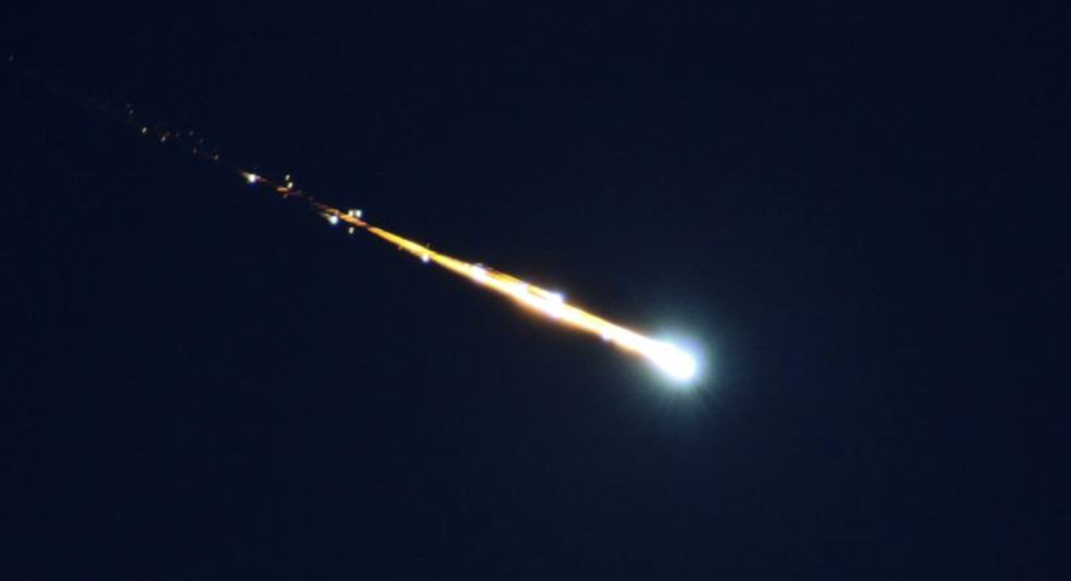 A fireball breaking apart in Earth's atmosphere.