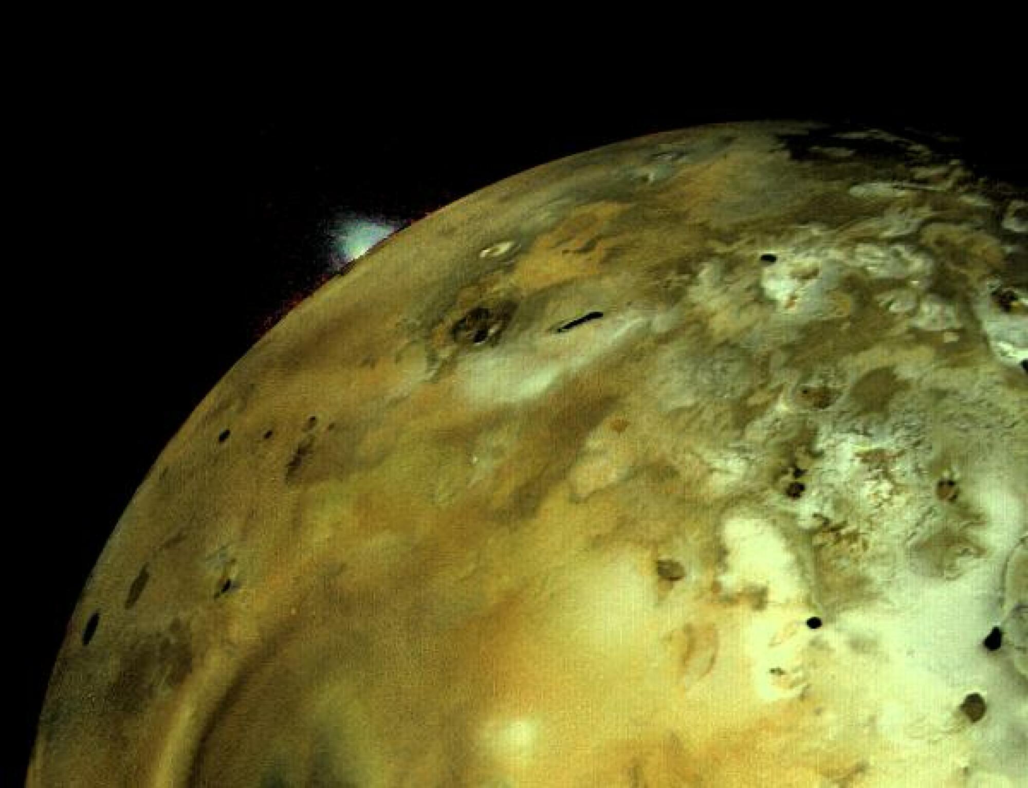 Voyager 1 captured this image of Io on March 4, 1979. A volcano is seen erupting on the moon's surface.