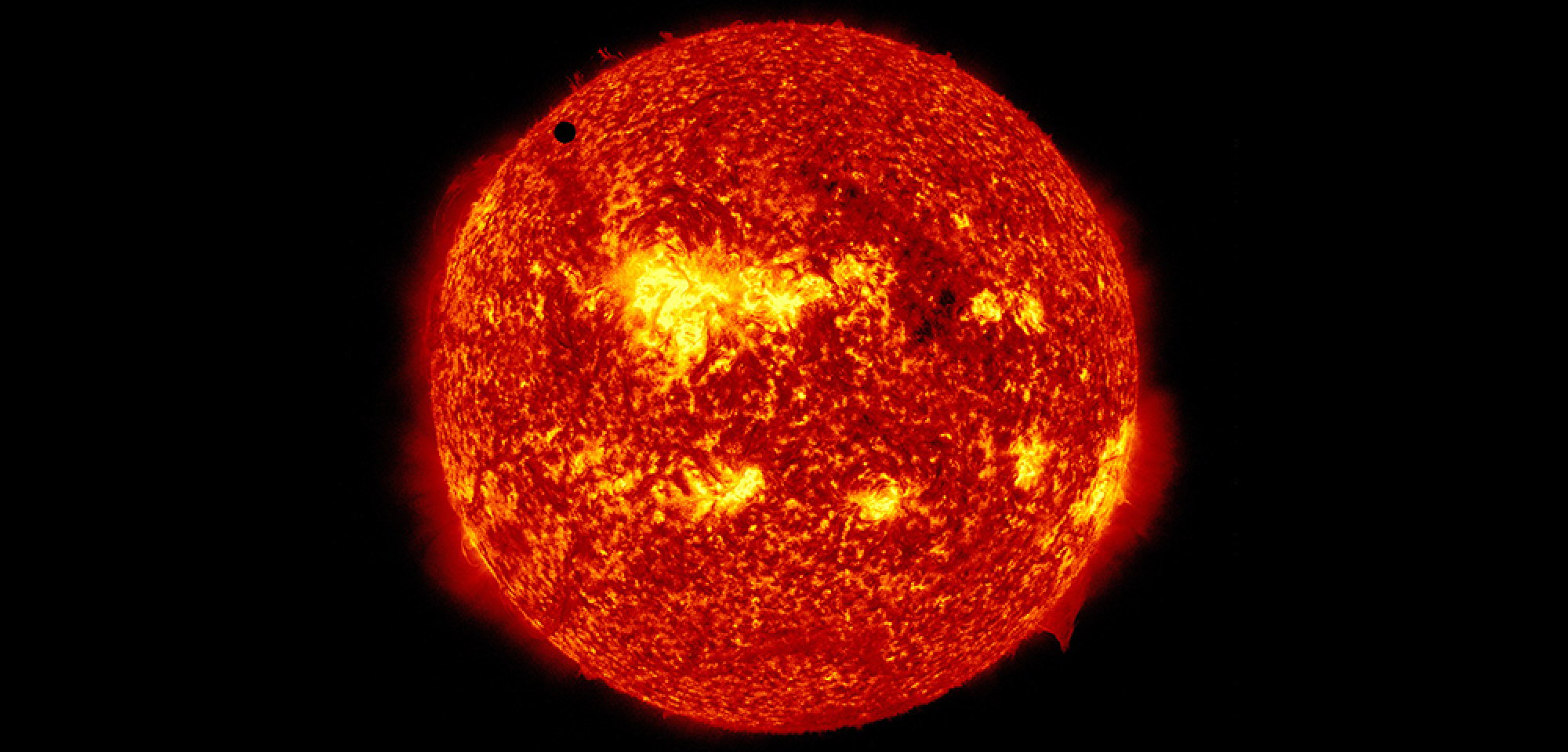 Venus visible as a tiny dot on the sun during the planet's transit.