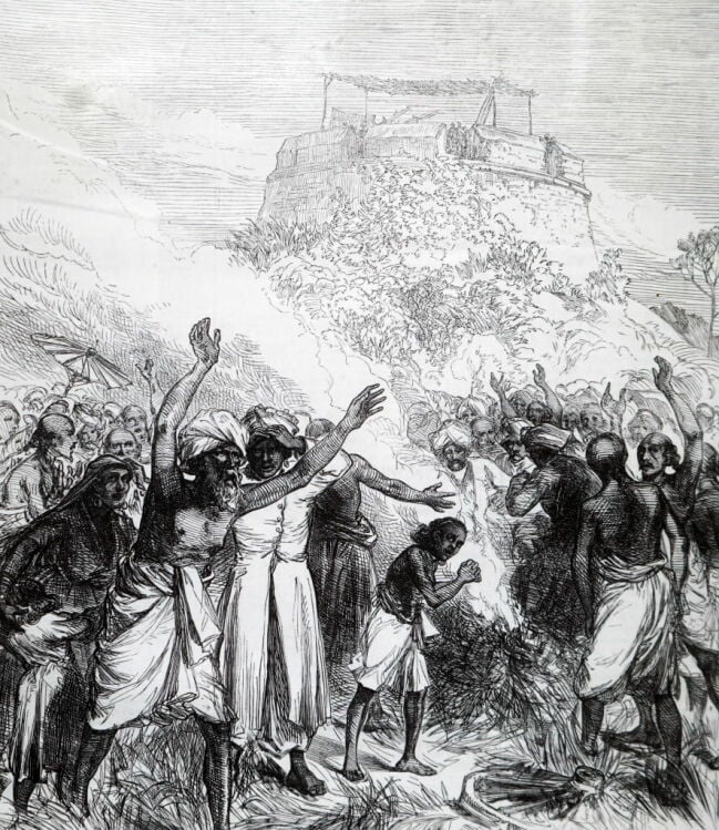 An engraving showing people in Bekul, Southern India, in 1871, expressing unease during a solar eclipse. A British expedition watches the event in a fort above.