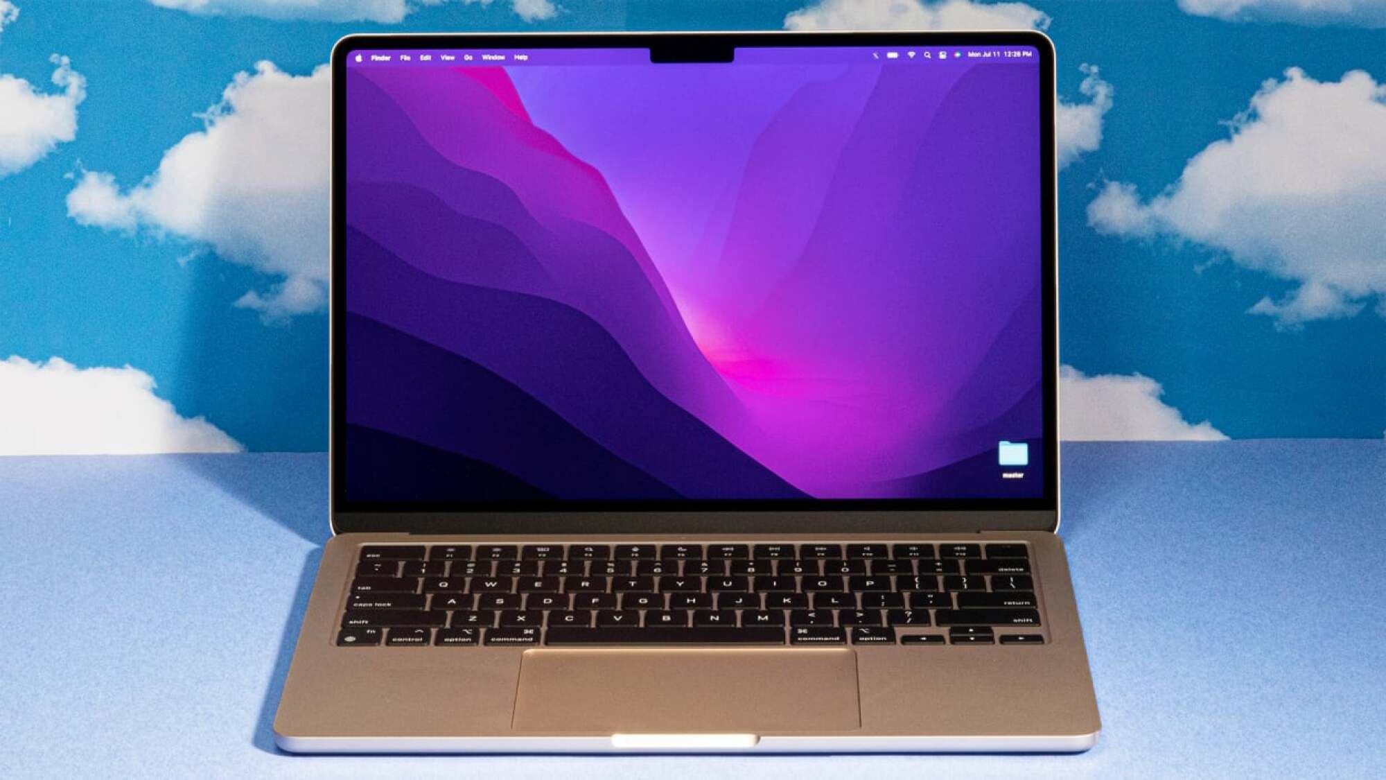 the 13-inch m2 apple macbook air against a cloud-patterned background