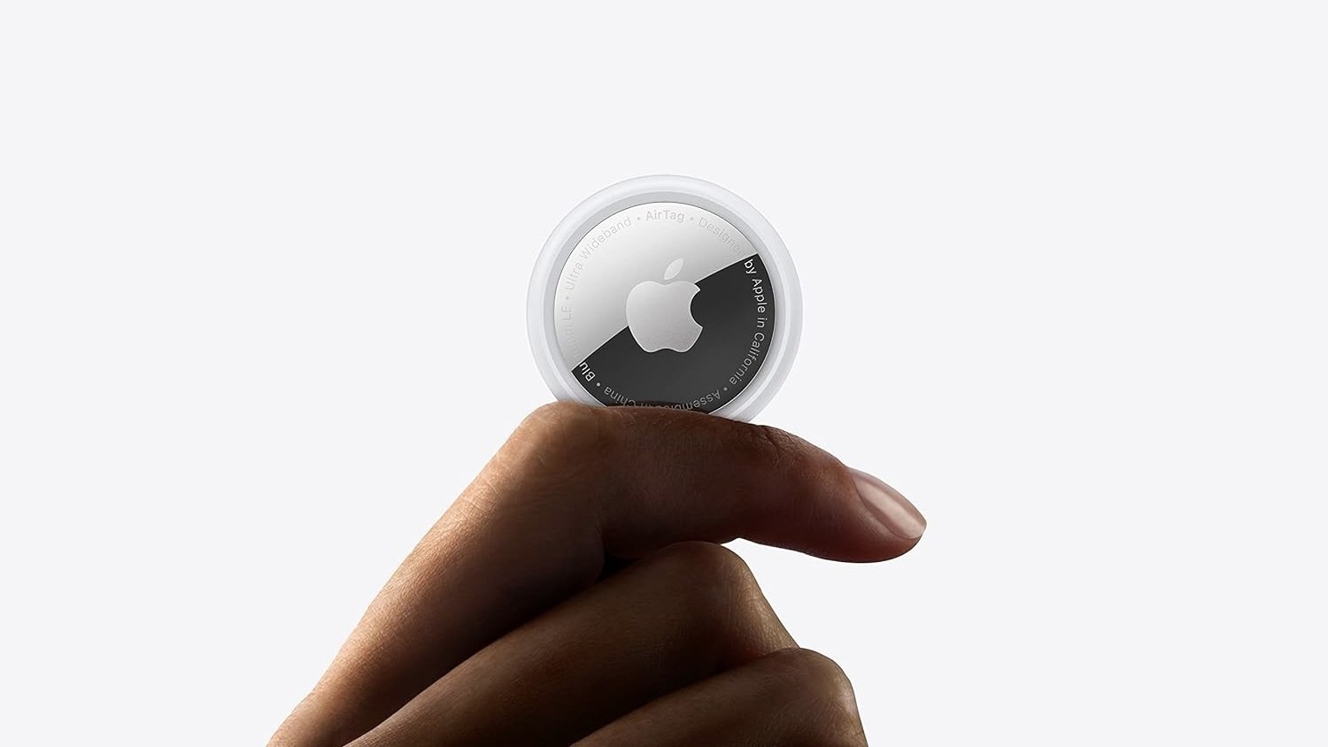 person holding apple airtag