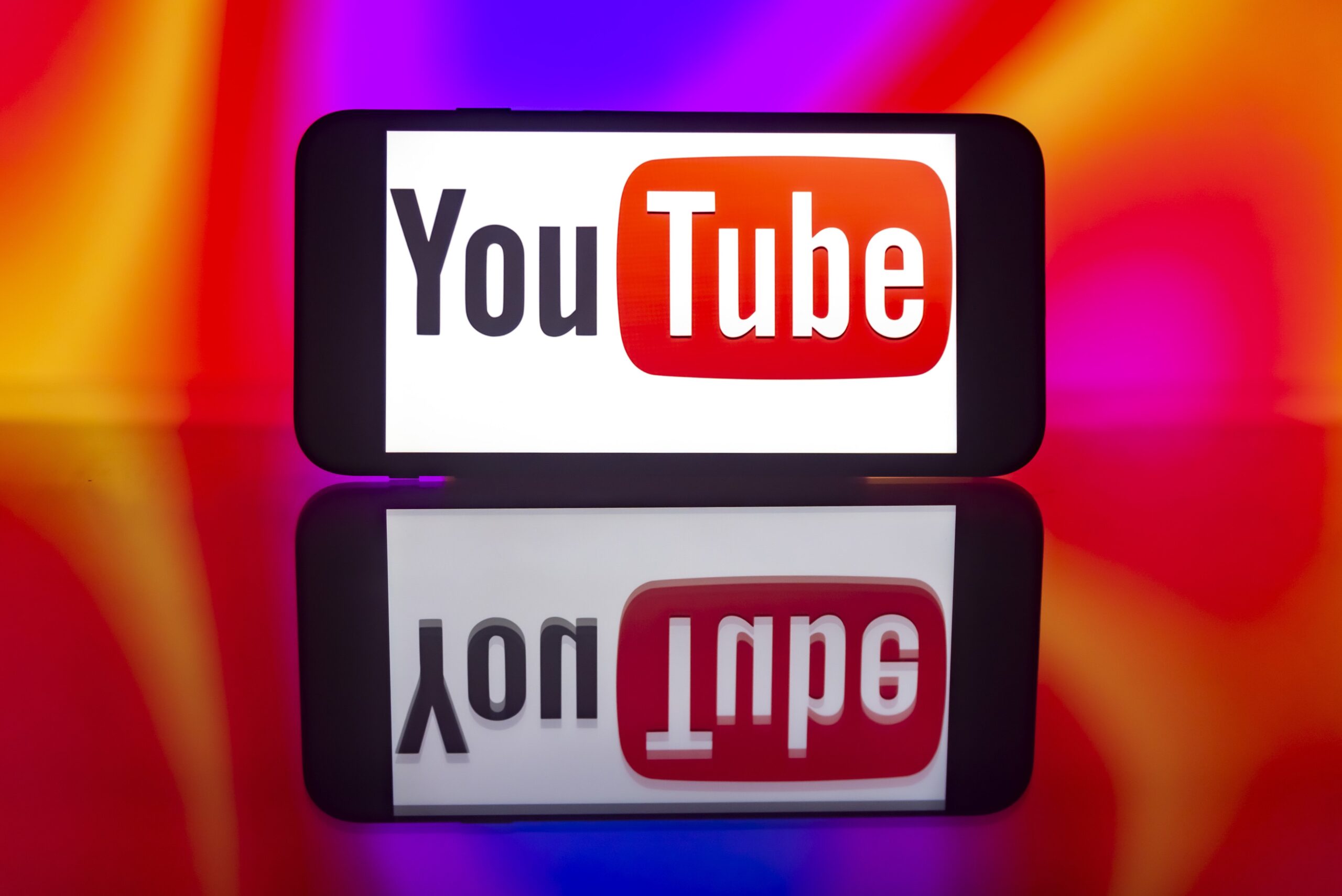A phone screen displaying the YouTube logo mirrored. 