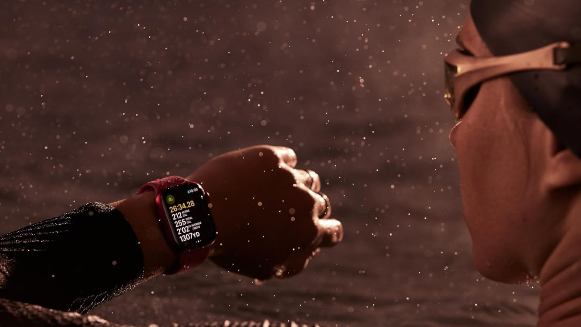 A swimmer looking at their Apple Watch while in the water