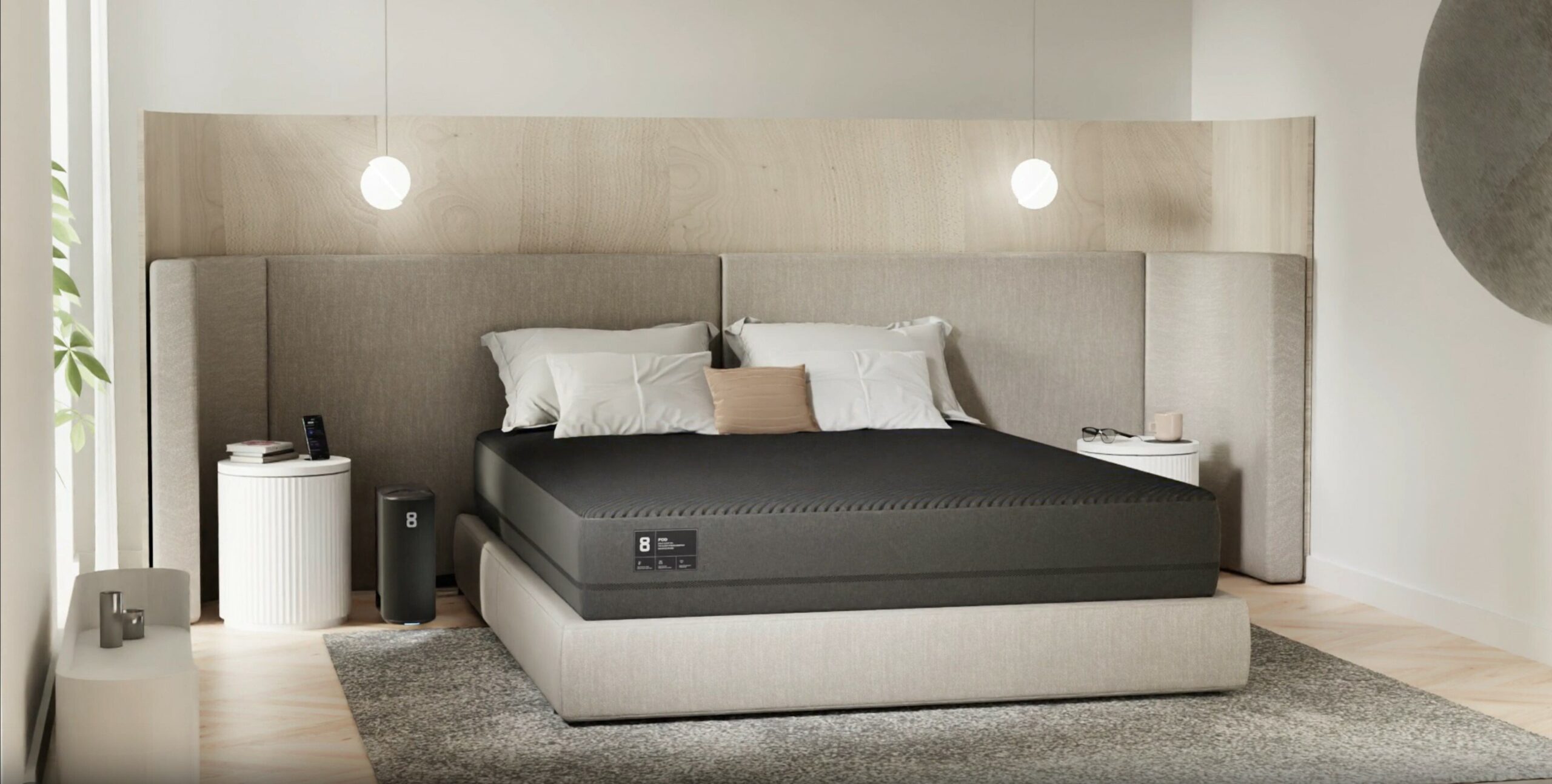 a bed sits in the center of a bedroom with the Eight Sleep Pod 3 cover over the mattress and pillows above the cover